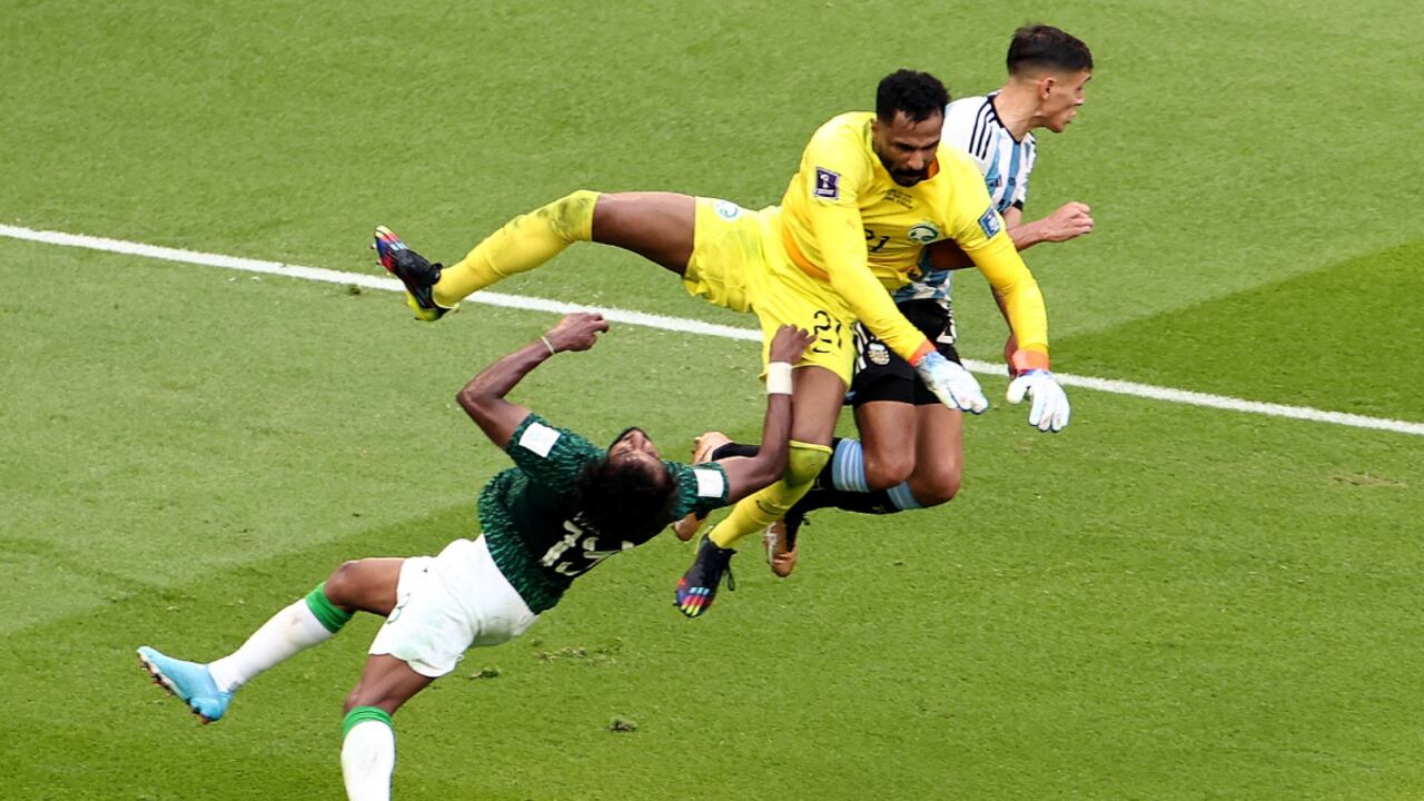 Soccer Football - FIFA World Cup Qatar 2022 - Group C - Argentina v Saudi Arabia - Lusail Stadium, Lusail, Qatar - November 22, 2022 Argentina's Nahuel Molina in action as Saudi Arabia's Mohammed Al-Owais collides into Yasser Al-Shahrani REUTERS/Marko Djurica TPX IMAGES OF THE DAY