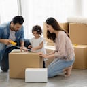 La familia acaba de comprar muebles nuevos y ayudó a organizar la casa. Mon padre e hija acaban de mudarse a un nuevo hogar. Desempacan la caja de paquetes y la arreglan en el piso de la sala de estar.