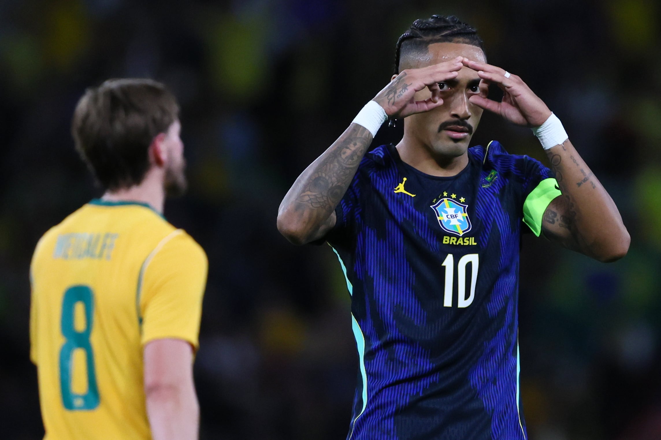 Brazil's Raphinha, right, celebrates scoring from a penalty as Australia's Connor Metcalfe walks past during their international friendly soccer match in Brisbane, Australia, on Tuesday, Sept. 29, 2026. (AP Photo/Tertius Pickard)