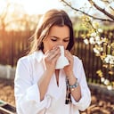 Attractive young adult woman coughing and sneezing outdoors. Sick people allergy or virus influenca concept.