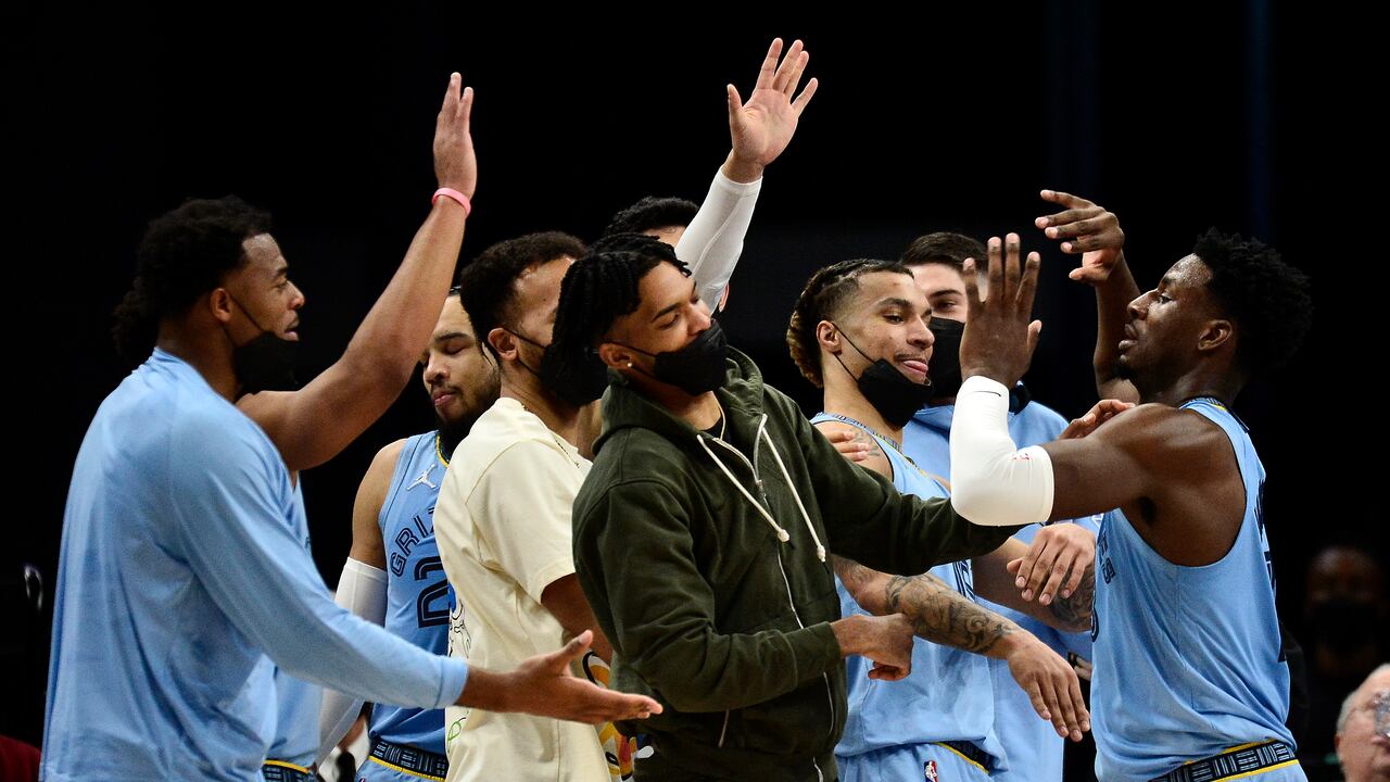 Memphis Grizzlies forward Jaren Jackson Jr., right, greets teammates in the first half of an NBA basketball game against the Oklahoma City Thunder, Thursday, Dec. 2, 2021, in Memphis, Tenn. (AP Photo/Brandon Dill)