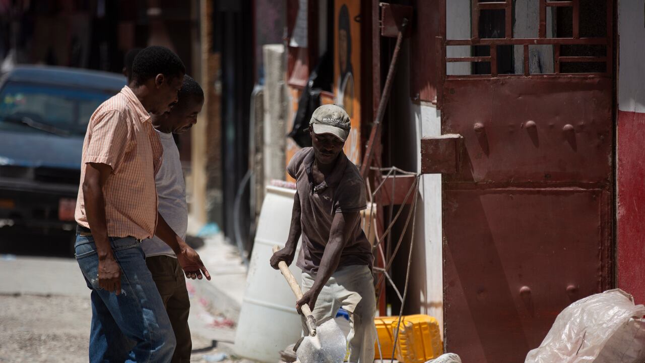 A worker shovels sands at a construction site in Port-au-Prince, Haiti, Saturday, Aug. 14, 2021. A 7.2 magnitude earthquake struck Haiti on Saturday, with the epicenter about 125 kilometers (78 miles) west of the capital of Port-au-Prince, the U.S. Geological Survey said. (AP Photo/Joseph Odelyn)