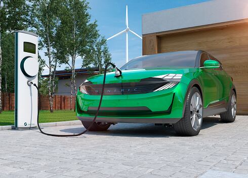 electric car SUV charging at home in front of modern low energy suburban house