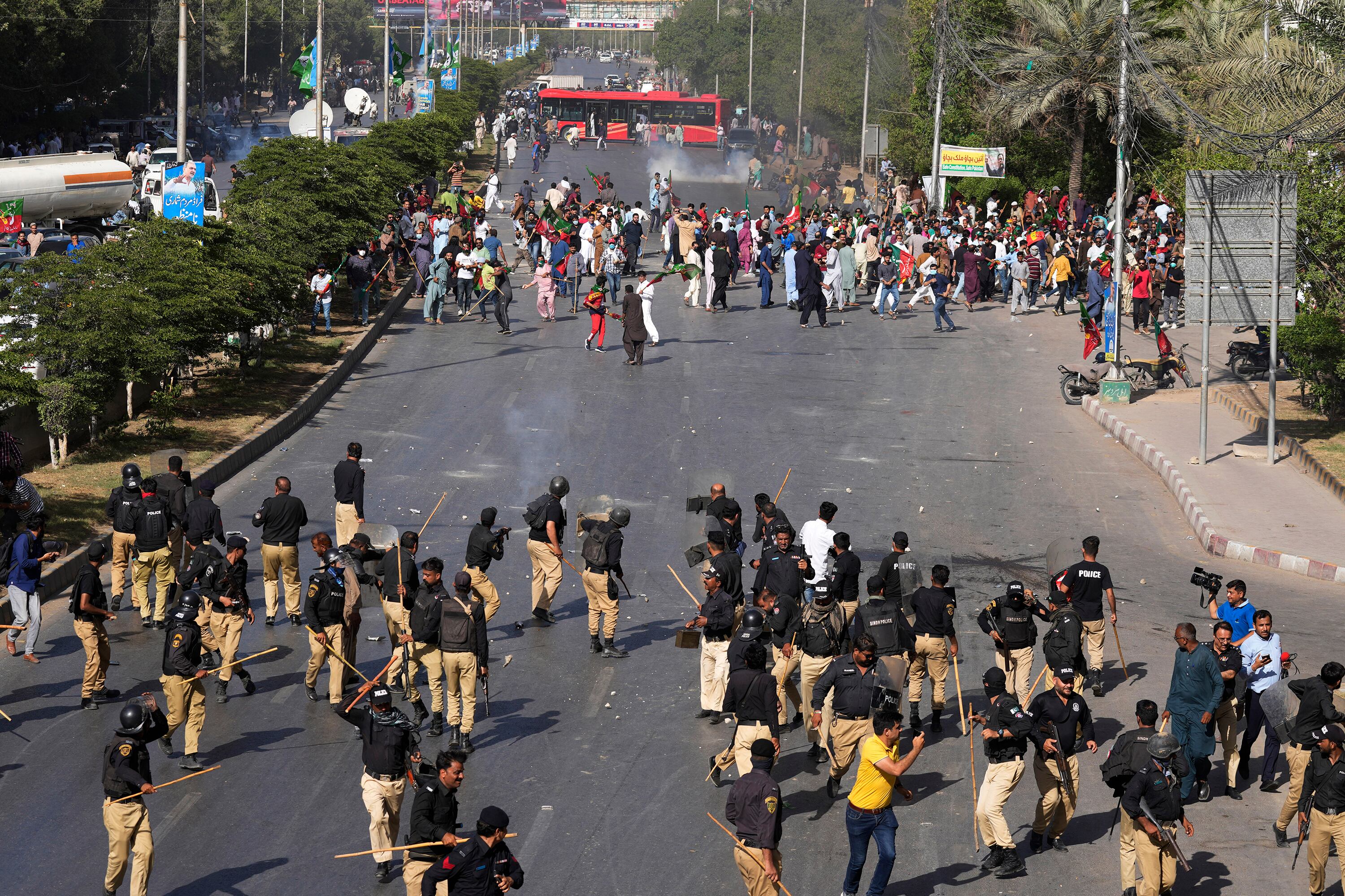 Oficiales de policía y simpatizantes del ex primer ministro de Pakistán, Imran Khan, intercambian piedras durante una protesta contra el arresto de Khan