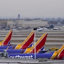 Four Southwest Airlines passenger jets sit at their gates at Chicago's Midway Airport as flight delays stemming from a computer outage at the Federal Aviation Administration has brought departures to a standstill across the U.S. Wednesday, Jan. 11, 2023, in Chicago. (AP Photo/Charles Rex Arbogast)