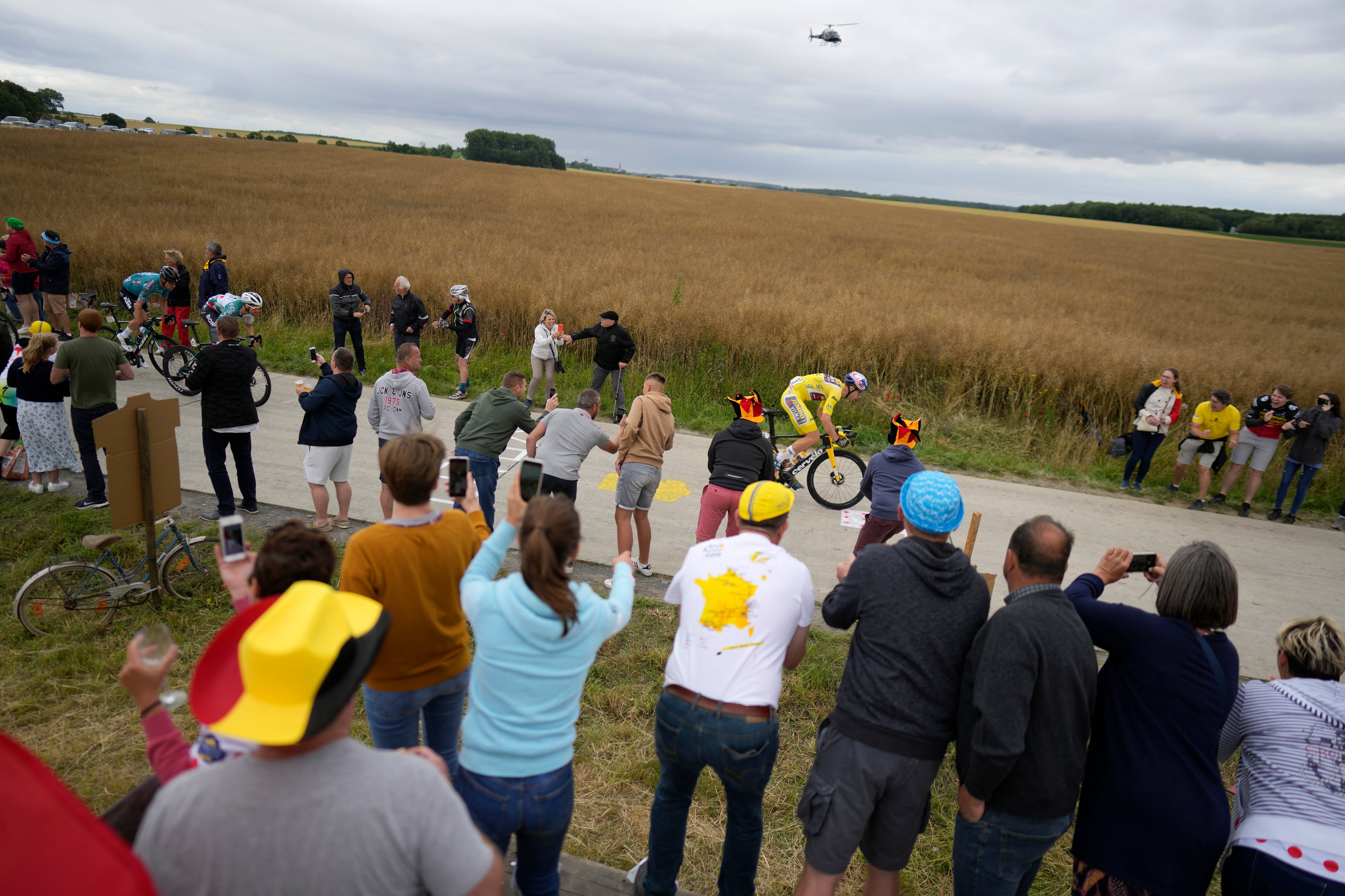Supporters of Belgium cheer Belgium's Wout Van Aert, wearing the overall leader's yellow jersey during the sixth stage of the Tour de France cycling race over 220 kilometers (136.7 miles) with start in Binche and finish in Longwy, France, Thursday, July 7, 2022. (AP Photo/Thibault Camus)
