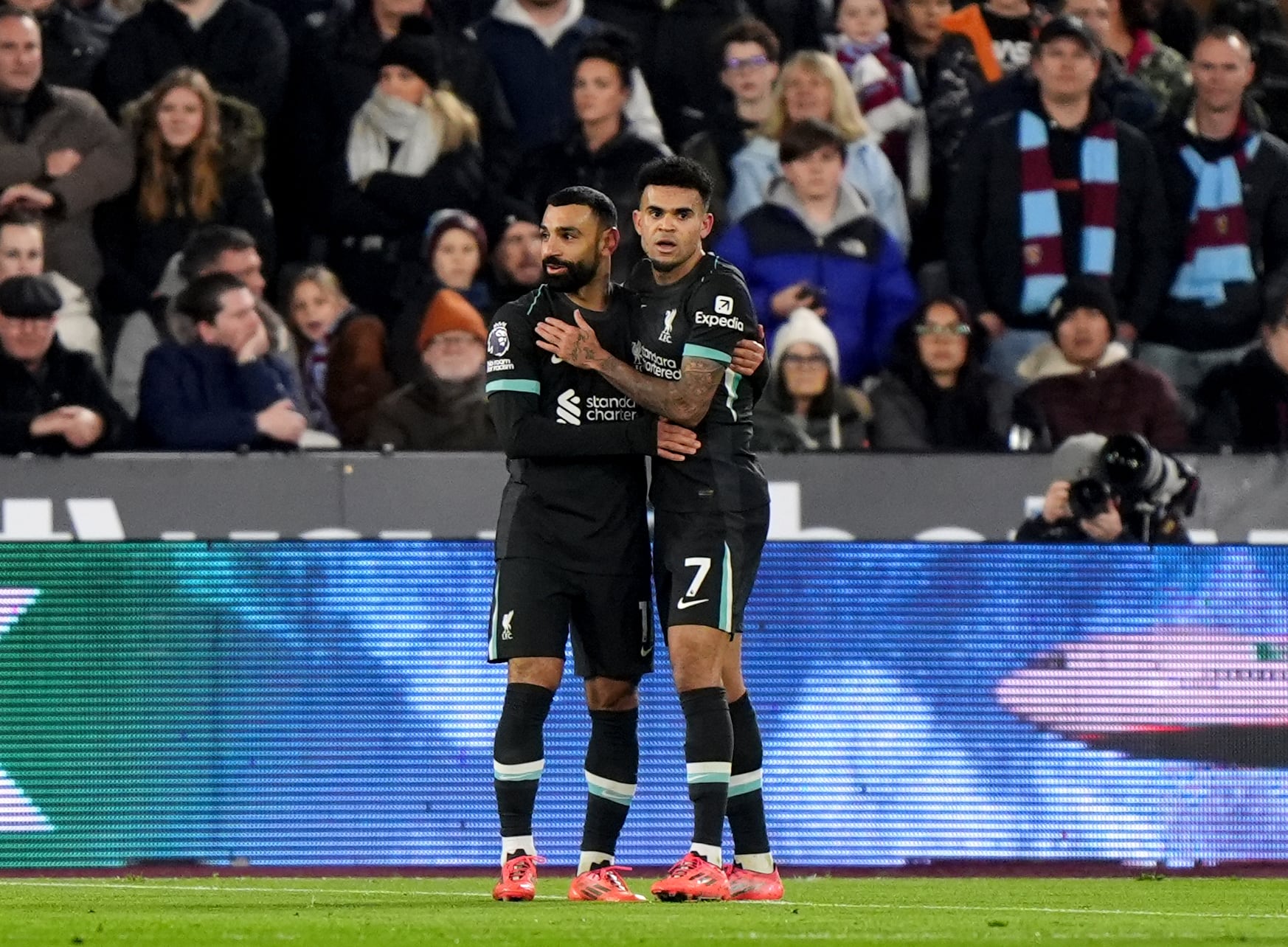 Liverpool's Luis Diaz (right) celebrates with Mohamed Salah after scoring his sides first goal during the Premier League match at the London Stadium, London. Picture date: Sunday December 29, 2024. (Photo by Bradley Collyer/PA Images via Getty Images)