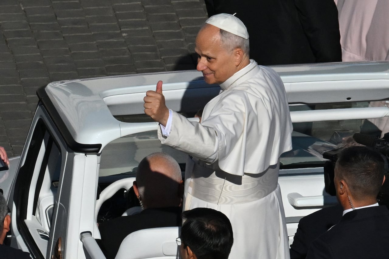 Pope Leo XIV (C) gestures to the crowd from the popemobile as he leaves at the end of the mass of Jubilee of Choirs and Choral Society at St. Peter's Square in The Vatican on November 23, 2025. (Photo by Andreas SOLARO / AFP)