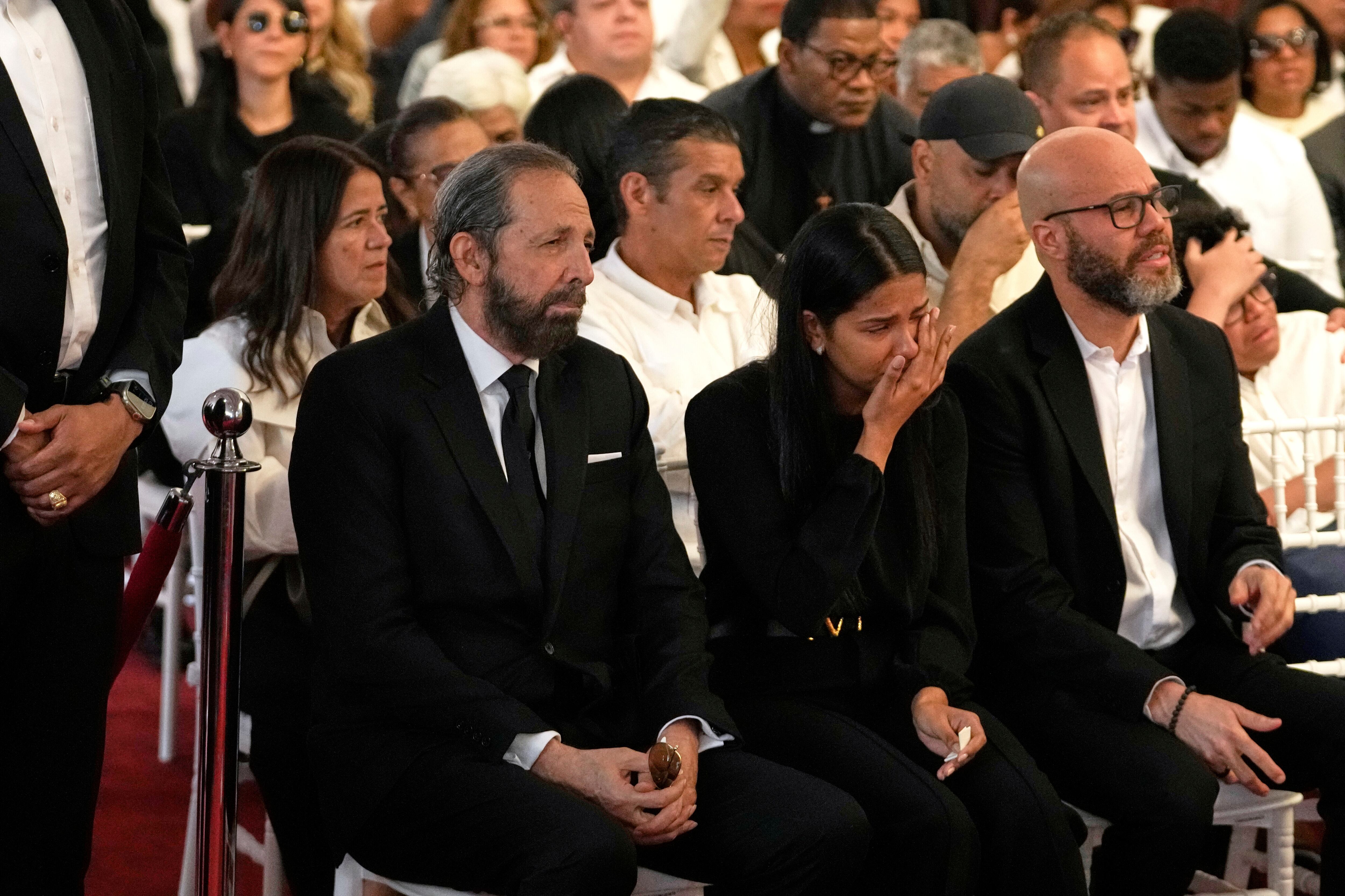 Dominican singer Juan Luis Guerra, left, attends a wake of Rubby Perez, the merengue singer who was performing at the Jet Set nightclub when its roof collapsed, killing more than 200 people, at the National Theater in Santo Domingo, Dominican Republic, Thursday, April 10, 2025. (AP Photo/Matias Delacroix)