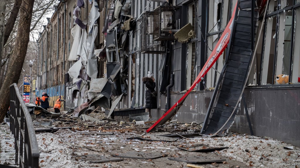 MYKOLAIV, UKRAINE - FEBRUARY 16: After the night drone attack by Russia, municipal services clean up debris on February 16, 2025 in Mykolaiv, Ukraine. Russian forces attacked Mykolaiv with drones, causing damage to a critical infrastructure facility. The strike caused a fire that was quickly extinguished by rescuers. Five residential buildings, at least four stores, a restaurant and office space were damaged by falling debris and the blast wave. A 64-year-old man was injured in the attack. Municipal services came to the aid of entrepreneurs. Specialists are quickly clearing the area, repairing damage, and helping to restore electricity and water supplies so that the city can return to normal life as soon as possible. (Photo by Serhii Ovcharyshyn/NikVesti.com/Global Images Ukraine via Getty Images)