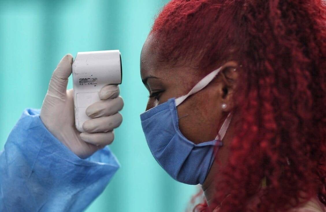 Profesionales de la salud, le toman la temperatura a los viajeros. Foto: Esteban Vega/SEMANA