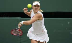 Germany's Angelique Kerber plays a return to Australia's Ashleigh Barty during the women's singles semifinals match on day ten of the Wimbledon Tennis Championships in London, Thursday, July 8, 2021. (AP Photo/Alberto Pezzali)