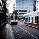 The MAX: Rail train cars coming and going on their tracks in downtown Portland city. (Some motion blur)