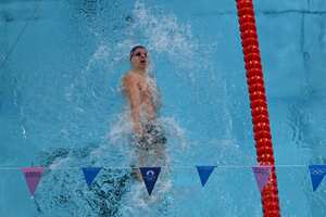 An overview shows France's Leon Marchand competing in a semifinal of the men's 200m individual medley swimming event during the Paris 2024 Olympic Games at the Paris La Defense Arena in Nanterre, west of Paris, on August 1, 2024. (Photo by Fran�ois-Xavier MARIT / AFP)
