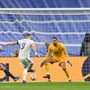 MADRID, SPAIN - MARCH 09: Karim Benzema of Real Madrid scores their team's first goal past Marquinhosn (L) and Gianluigi Donnarumma of Paris Saint-Germain during the UEFA Champions League Round Of Sixteen Leg Two match between Real Madrid and Paris Saint-Germain at Estadio Santiago Bernabeu on March 09, 2022 in Madrid, Spain. (Photo by David Ramos/Getty Images)