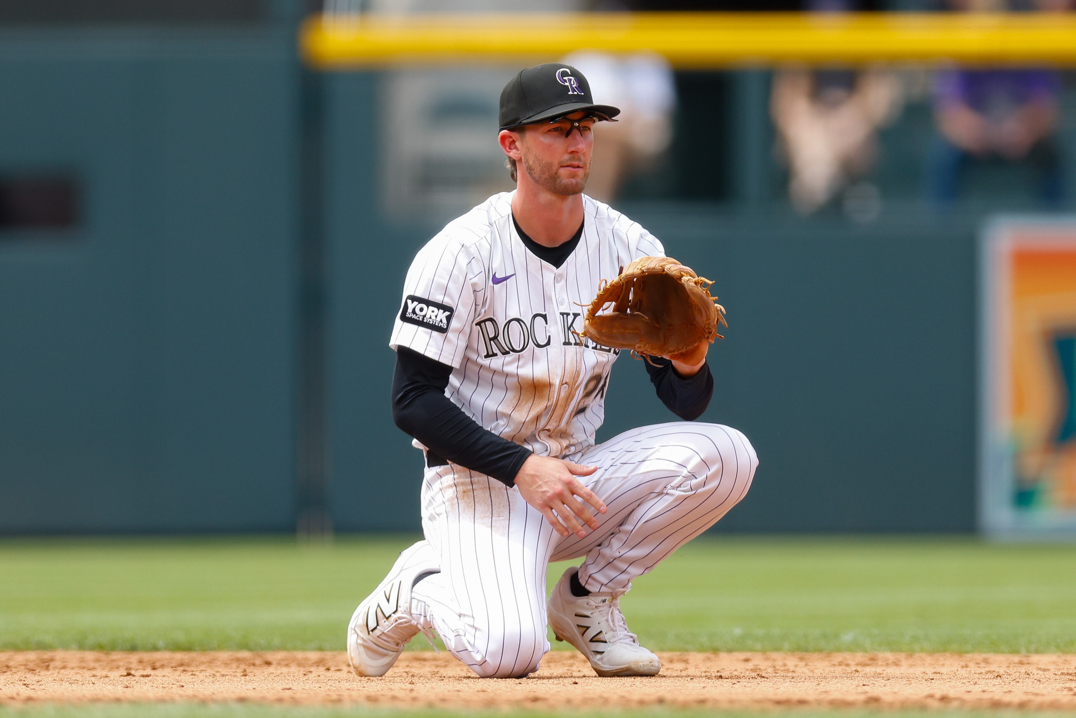 DENVER, CO - JULY 23:  Ryan McMahon #24 of the Colorado Rockies crouches down and awaits a throw in the sixth inning against the St. Louis Cardinals at Coors Field on July 23, 2025 in Denver, Colorado. (Photo by Justin Edmonds/Getty Images)