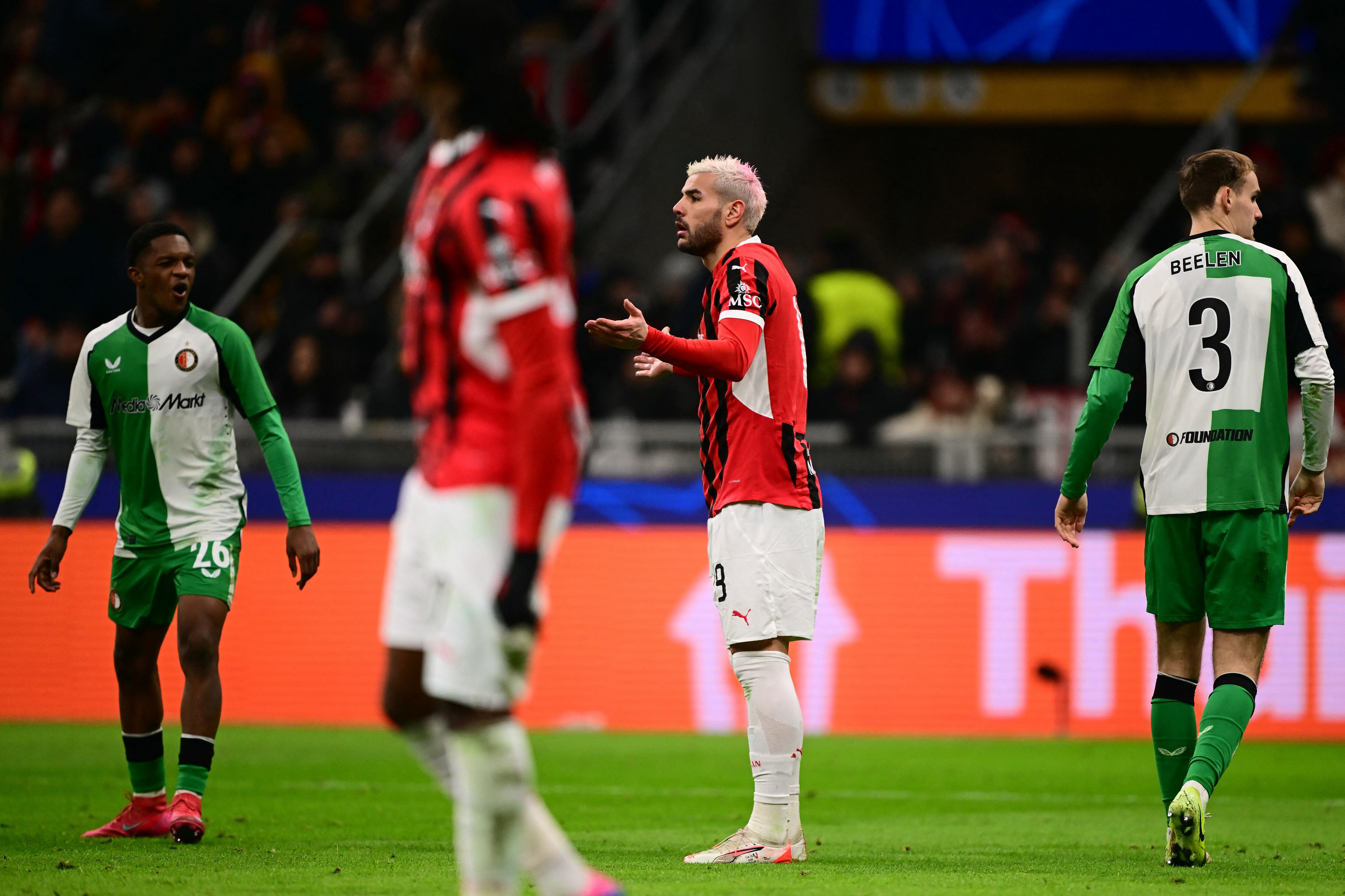 AC Milan's French defender #19 Theo Hernandez (C) reacts after he received a red card during the UEFA Champions League knockout round play-off second leg football match between AC Milan and Feyenoord at San Siro stadium in Milan, on February 18, 2025. (Photo by Marco BERTORELLO / AFP)