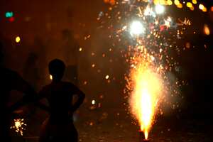 Mpd 5159: A young boy watching the fire crackers bursting in marine drive in south Bombay now Mumbai, Maharashtra, India.