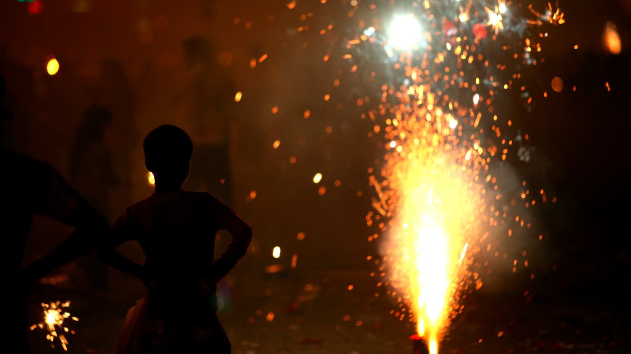 Mpd 5159: A young boy watching the fire crackers bursting in marine drive in south Bombay now Mumbai, Maharashtra, India.