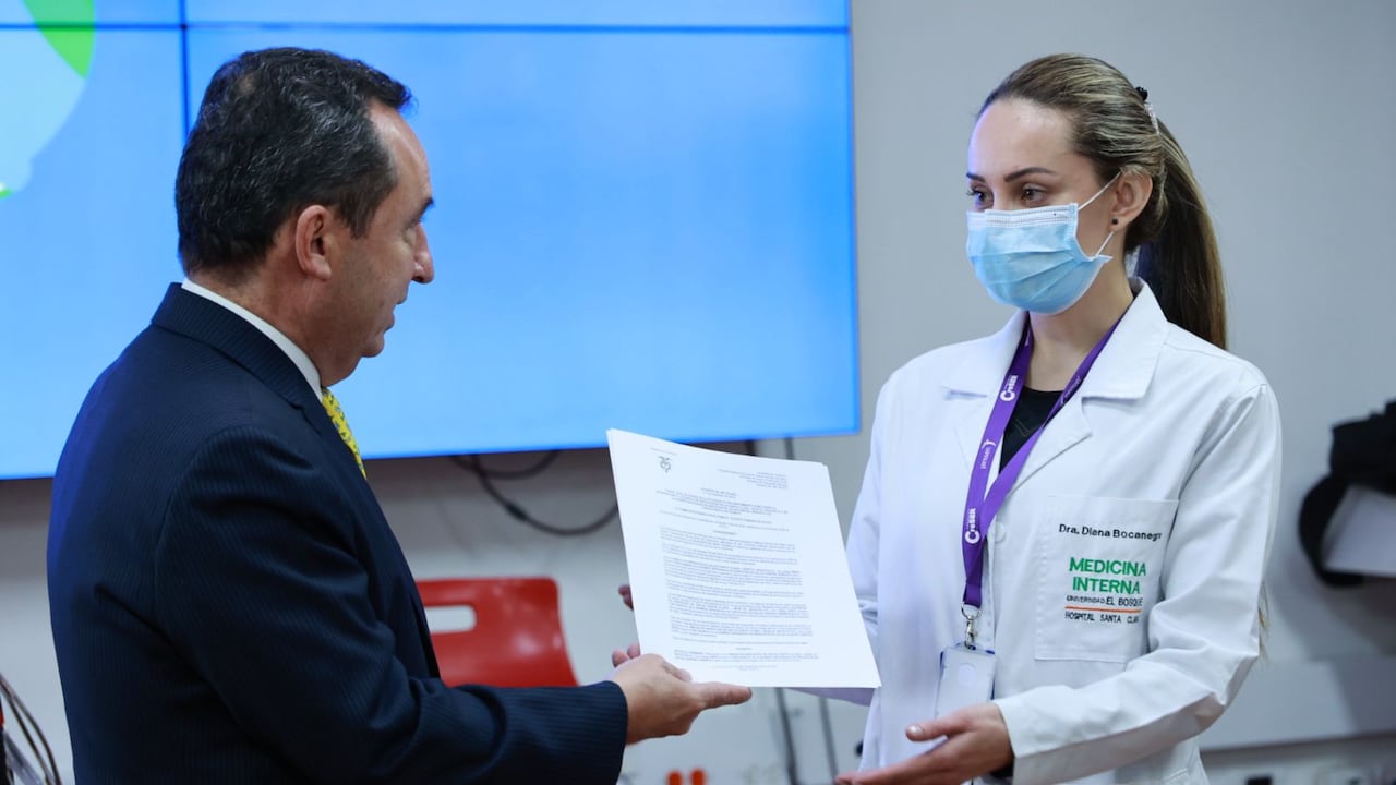 La doctora Diana Bocanegra recibe del secretario de Salud, Alejandro Gómez, la certificación como Hospital Universitario Santa Clara.