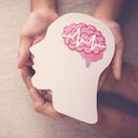 Adult and child hands holding encephalography brain paper cutout, Epilepsy and alzheimer awareness, seizure disorder, mental health concept