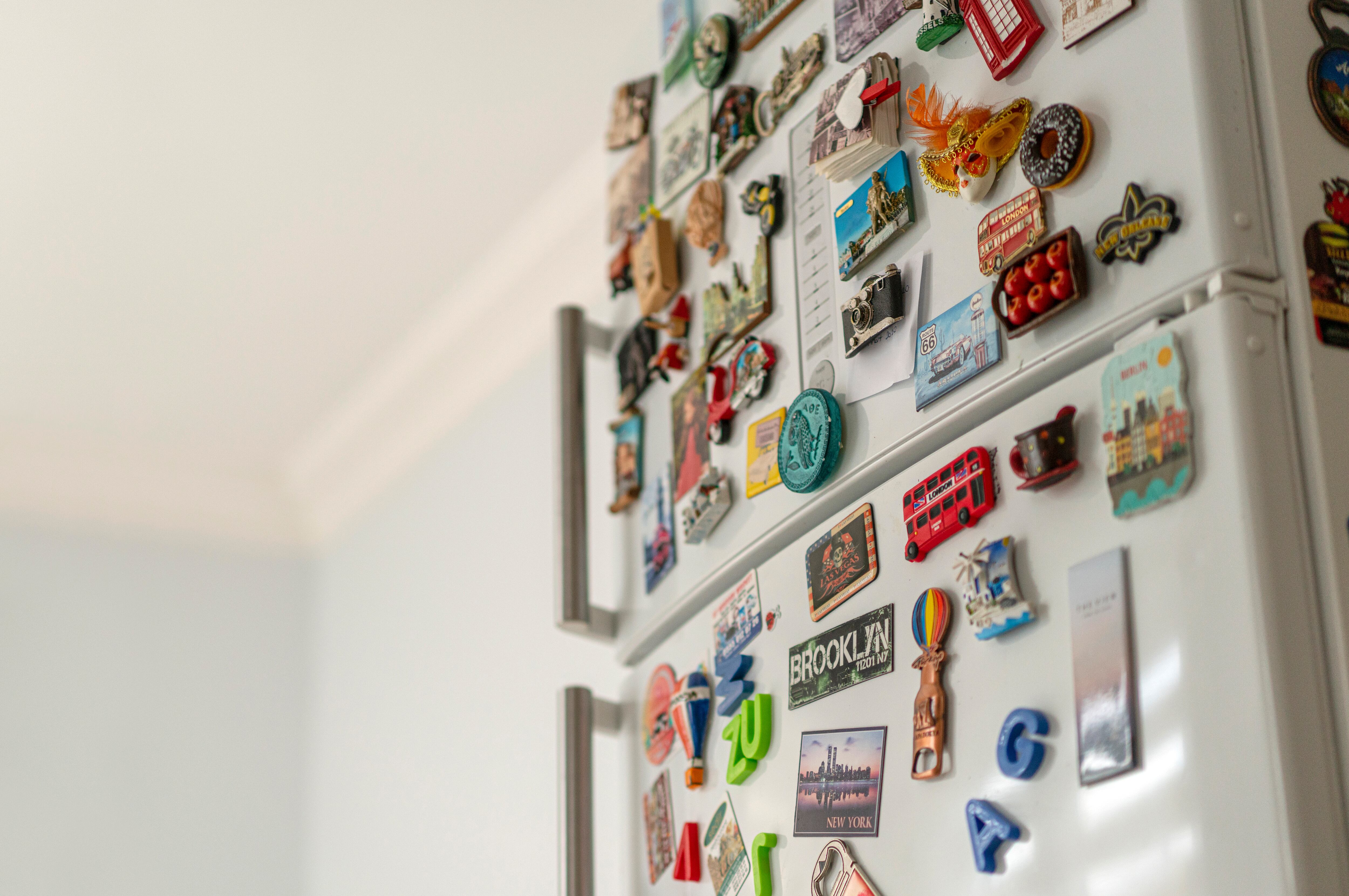 Lots of various souvenir magnets on the fridge in the kitchen