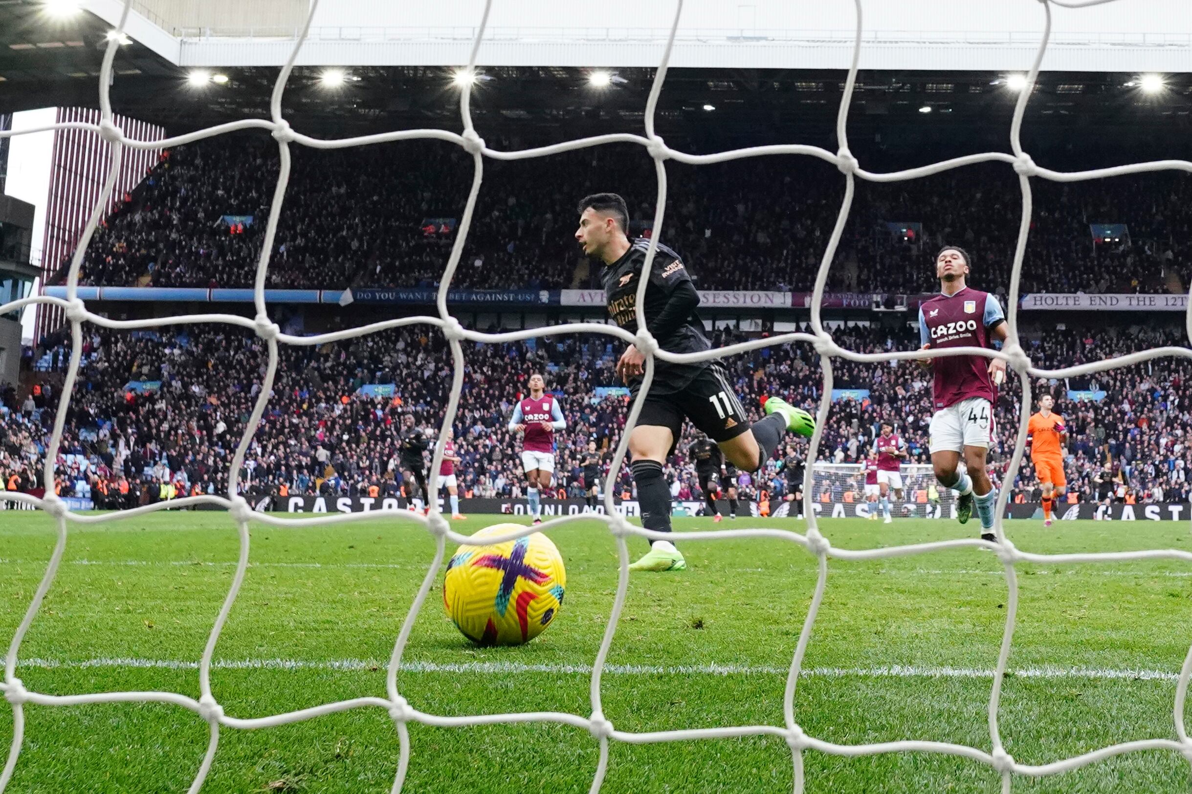 Arsenal's Gabriel Martinelli, centre, scores his side's fourth goal during the English Premier League soccer match between Aston Villa and Arsenal at Villa Park in Birmingham, England, Saturday, Feb. 18, 2023. (AP Photo/Jon Super)