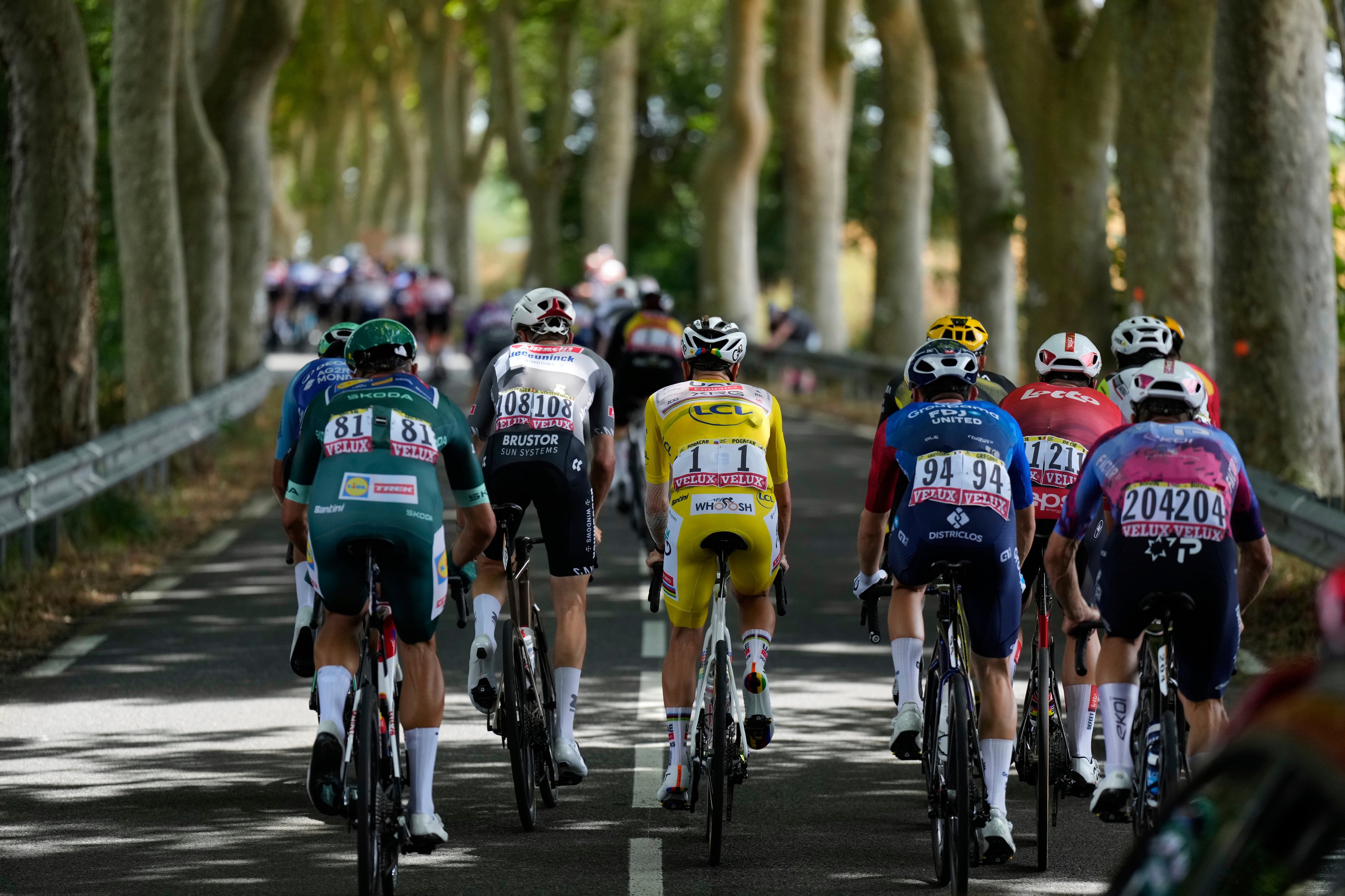 The group with Slovenia's Tadej Pogacar, wearing the overall leader's yellow jersey, center, rides during the fifteenth stage of the Tour de France cycling race over 169.3 kilometers (105.2 miles) with start in Muret and finish in Carcassone, France, Sunday, July 20, 2025. (AP Photo/Mosa'ab Elshamy)