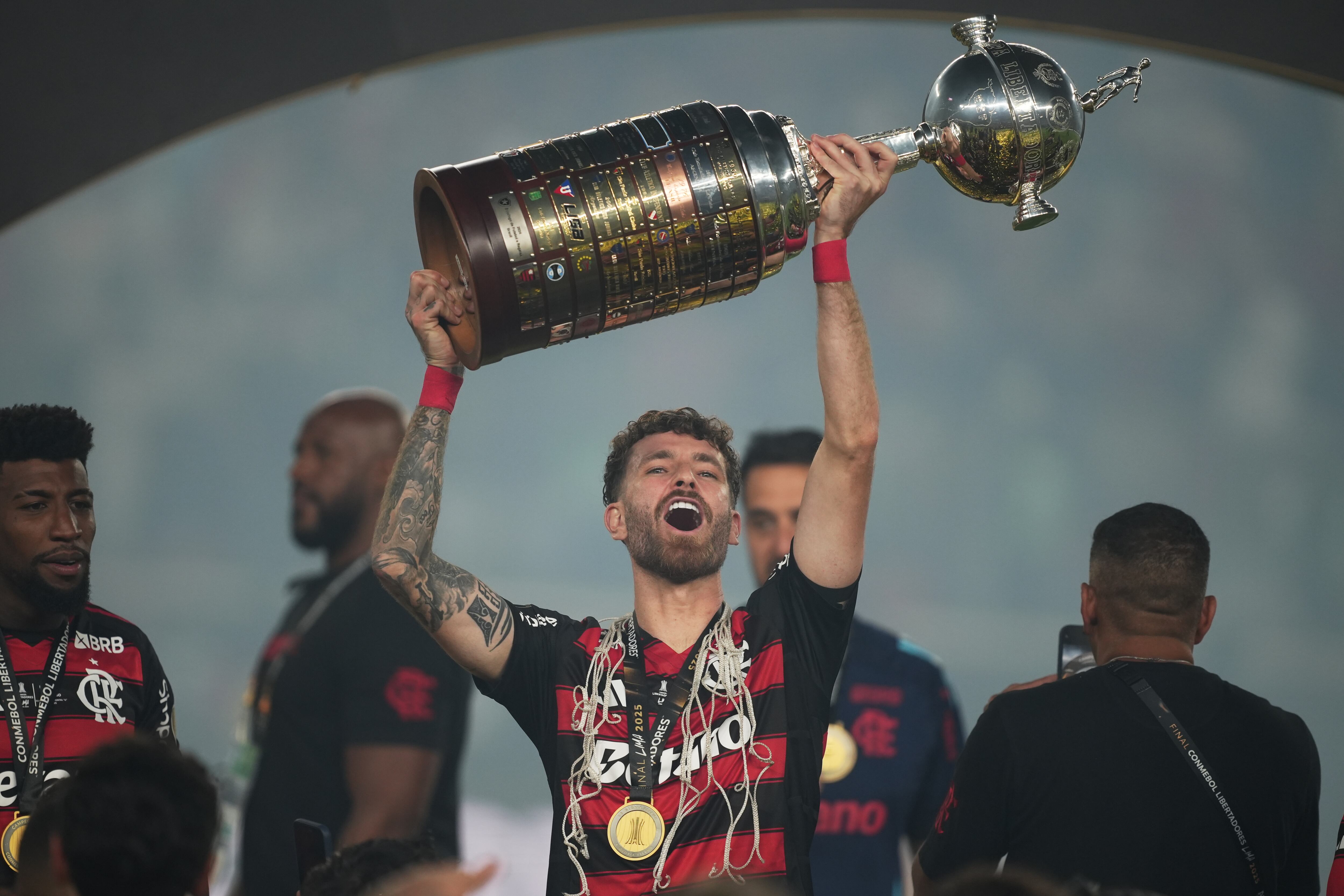 Leo Pereira of Brazil's Flamengo celebrates with the trophy after defeating Brazil's Palmeiras in the Copa Libertadores final soccer match in Lima, Peru, Saturday, Nov. 29, 2025. (AP Photo/Guadalupe Pardo)