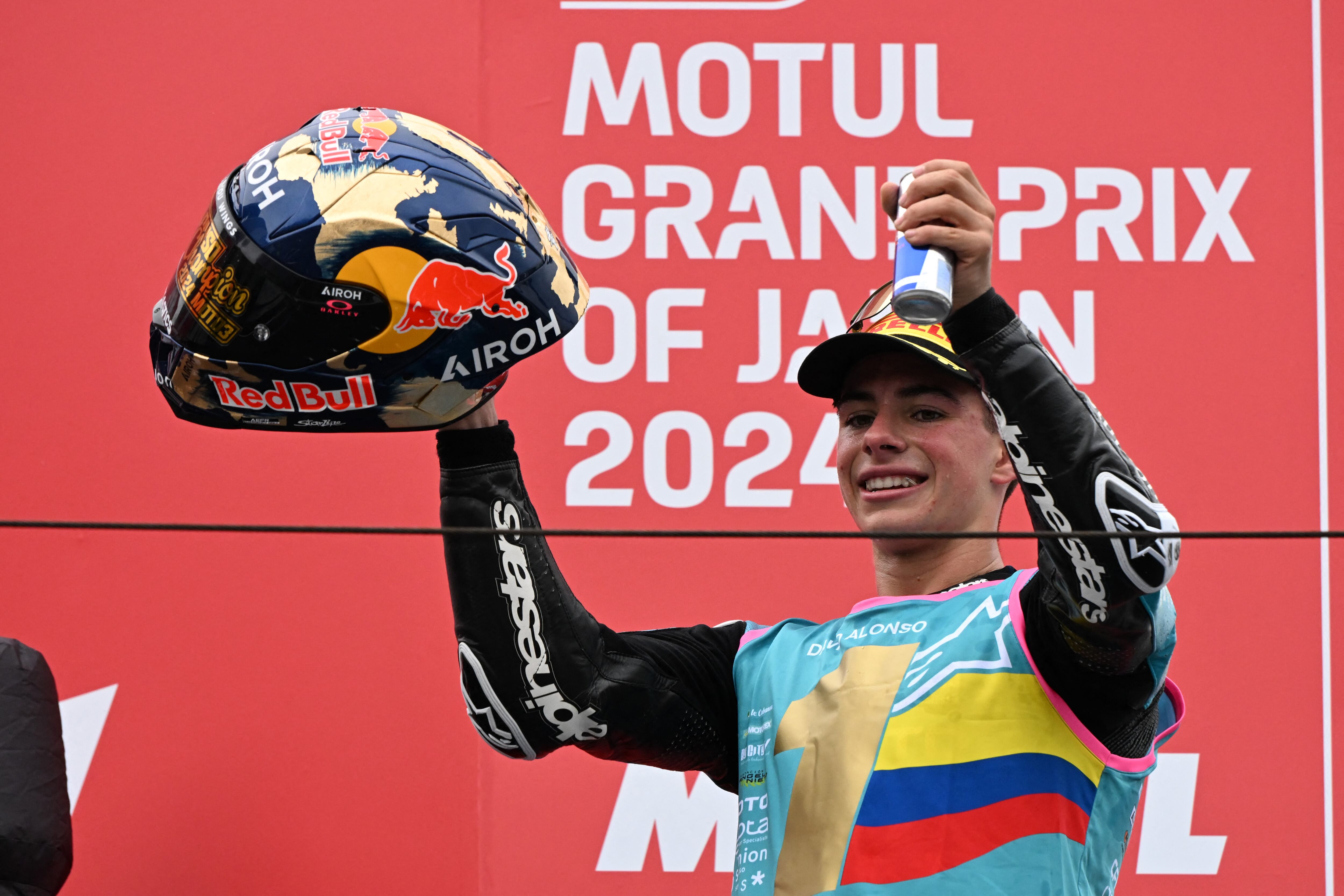 CFMOTO Aspar Team rider David Alonso of Colombia celebrates his victory and the 2024 World Champion on the podium after winning the Moto3 class race of the MotoGP Japanese Grand Prix at the Mobility Resort Motegi in Motegi, Tochigi prefecture on October 6, 2024. (Photo by Toshifumi KITAMURA / AFP)