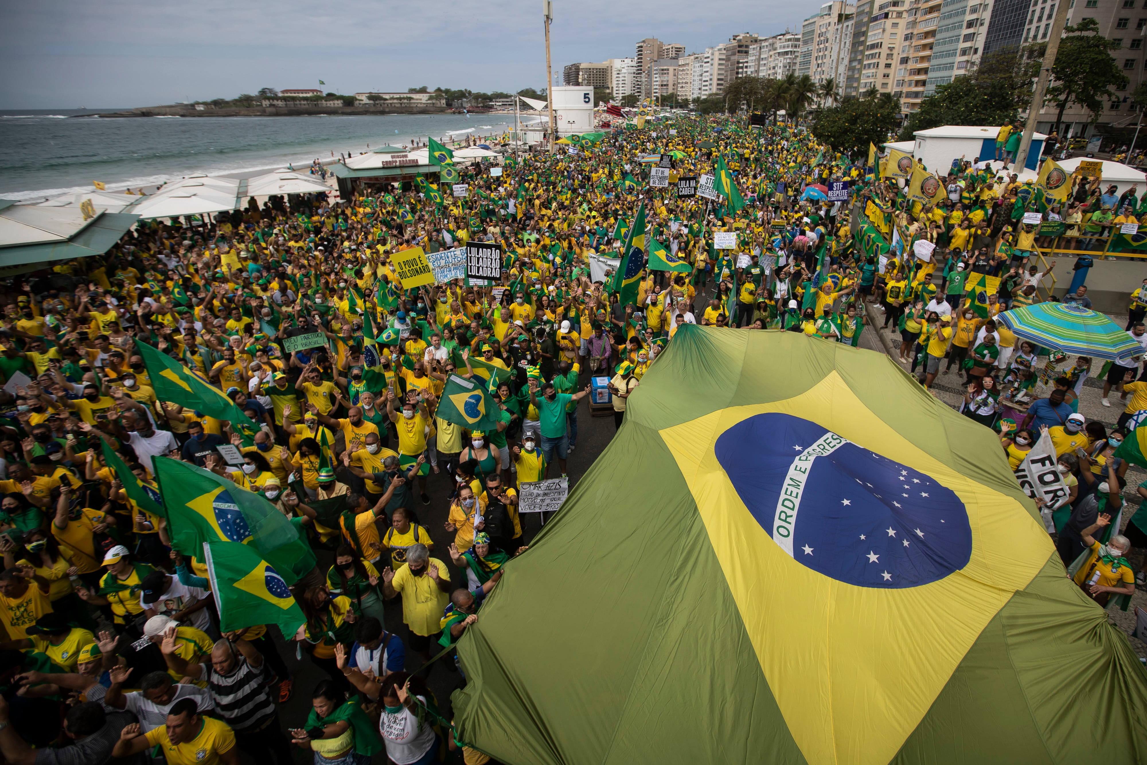 Los partidarios del presidente brasileño, Jair Bolsonaro, llevan la bandera nacional de Brasil a lo largo de la playa de Copacabana el Día de la Independencia en Río de Janeiro, Brasil, el martes. 7, 2021. (AP Photo/Bruna Prado)