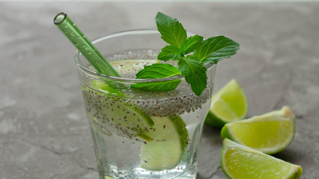 Glass of water with chia seeds and lime on a gray background. A healthy drink for weight loss.