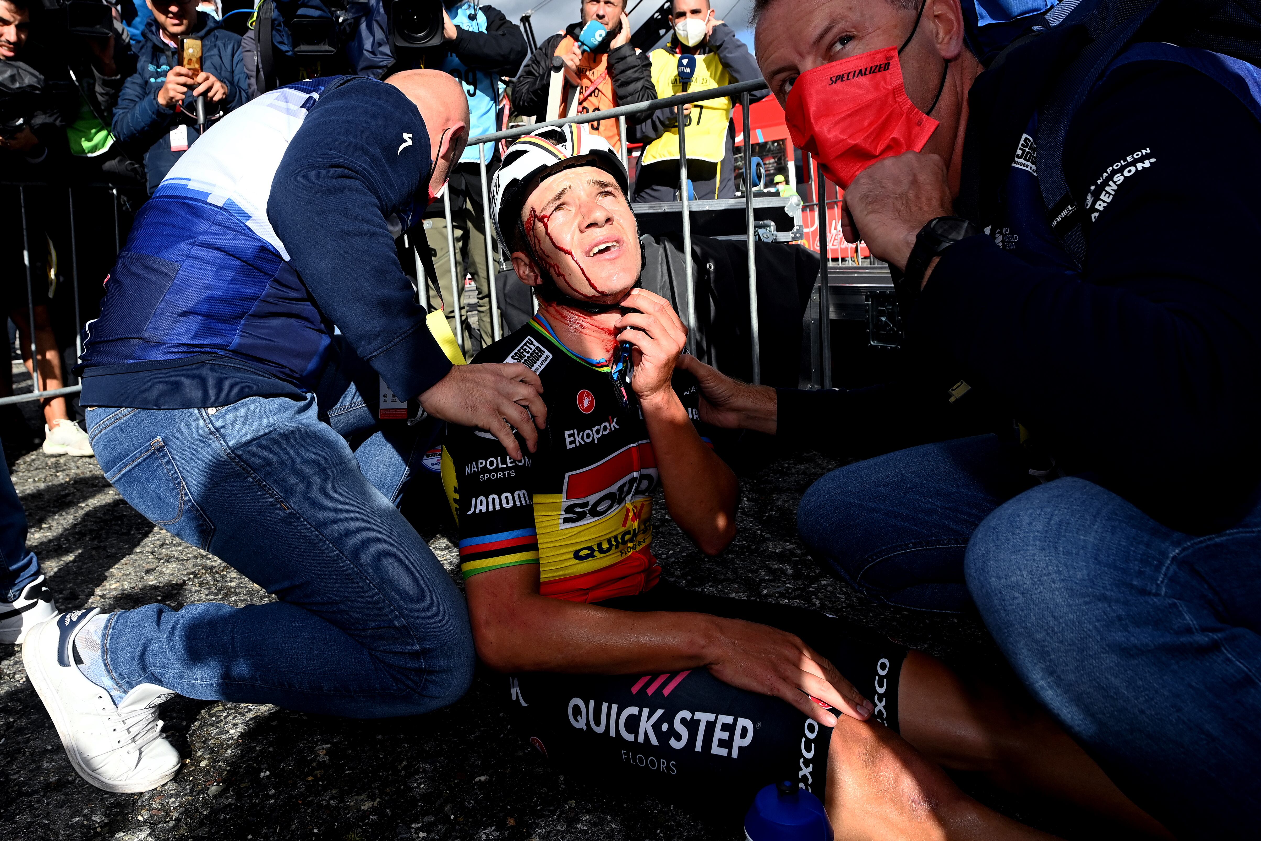 ARINSAL, SPAIN - AUGUST 28: Remco Evenepoel of Belgium and Team Soudal - Quick Step injured after winning the stage and colliding with medic Raquel Ortolano of Spain's Team Astana Qazaqstan during the 78th Tour of Spain 2023, Stage 3 a 158.5km stage from Súria to Arinsal 1911m/ #UCIWT / on August 28, 2023 in Arinsal, Andorra. (Photo by Tim de Waele/Getty Images)