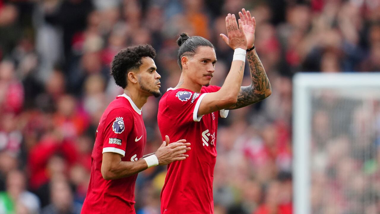 Liverpool's Luis Diaz, left, and Liverpool's Darwin Nunez coming off to get substituted during the English Premier League soccer match between Liverpool and West Ham at the Anfield stadium in Liverpool, England, Sunday, Sept. 24, 2023. (AP Photo/Jon Super)