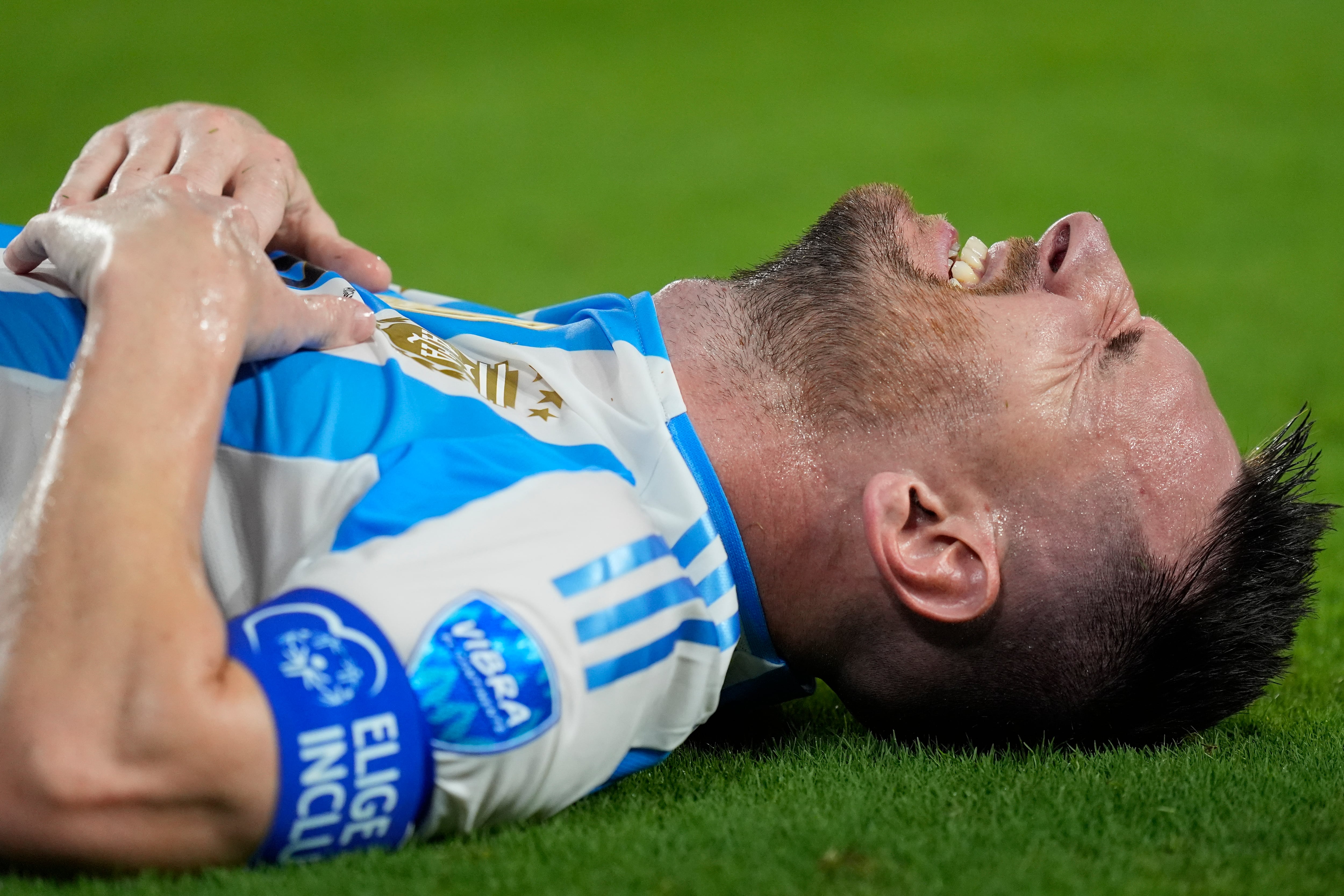 Argentina's Lionel Messi grimaces during the Copa America final soccer match against Colombia in Miami Gardens, Fla., Sunday, July 14, 2024. (AP Photo/Rebecca Blackwell)