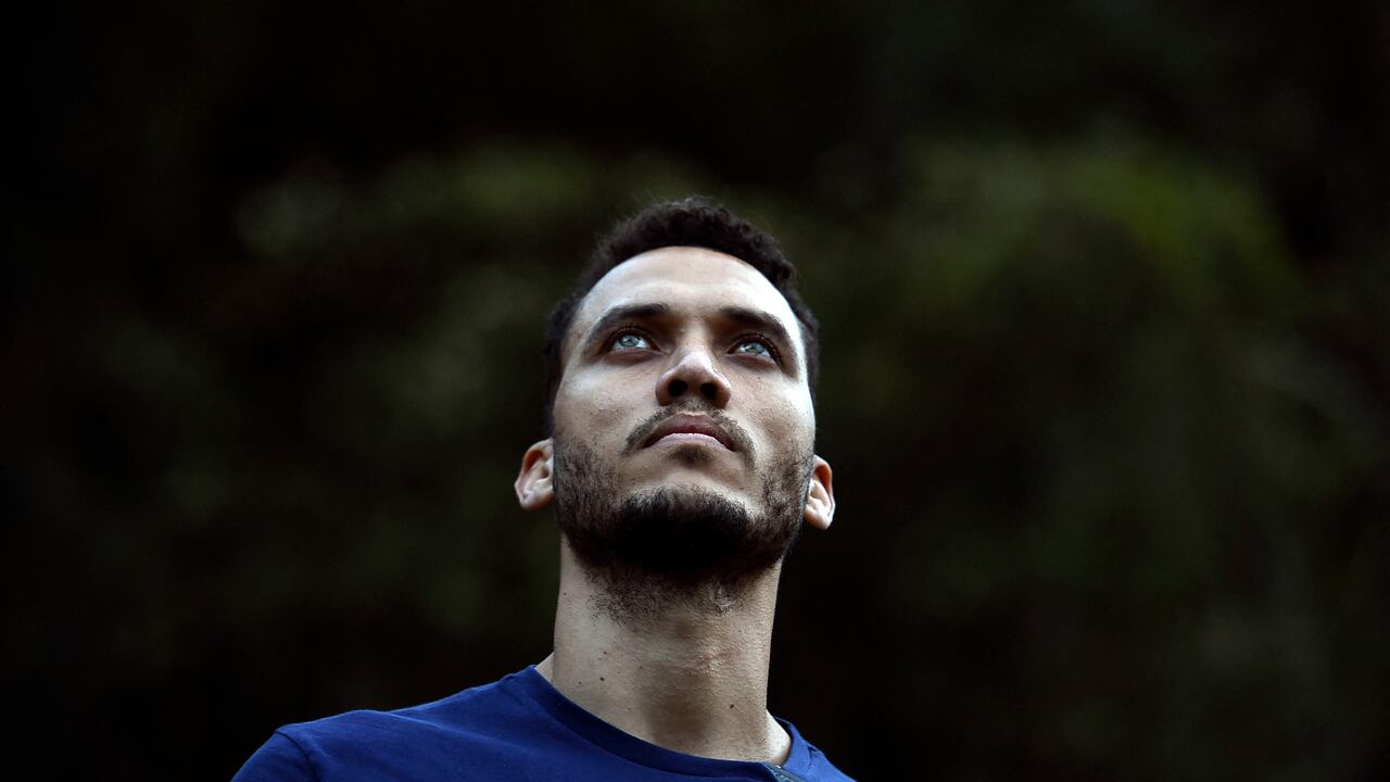 Former Brazilian football player Helio Neto (R) -a survivor of the Lamia flight 2933 plane crash that wiped out Brazilian football club Chapecoense- stands after planting a tree in tribute to the victims of the accidente at the Chapeco hill, on the fifth anniversary of the accident, near La Union, in Antioquia Department, Colombia, on December 1, 2021. - The plane was flying Chapecoense to Medellin to take on Atletico Nacional in the Copa Sudamericana finals -- the biggest and most unexpected game in the Brazilian team's history. When the plane ran out of fuel and went down in inhospitable mountains near its destination, 71 of the 77 aboard died, including 19 players. (Photo by JOAQUIN SARMIENTO / AFP)