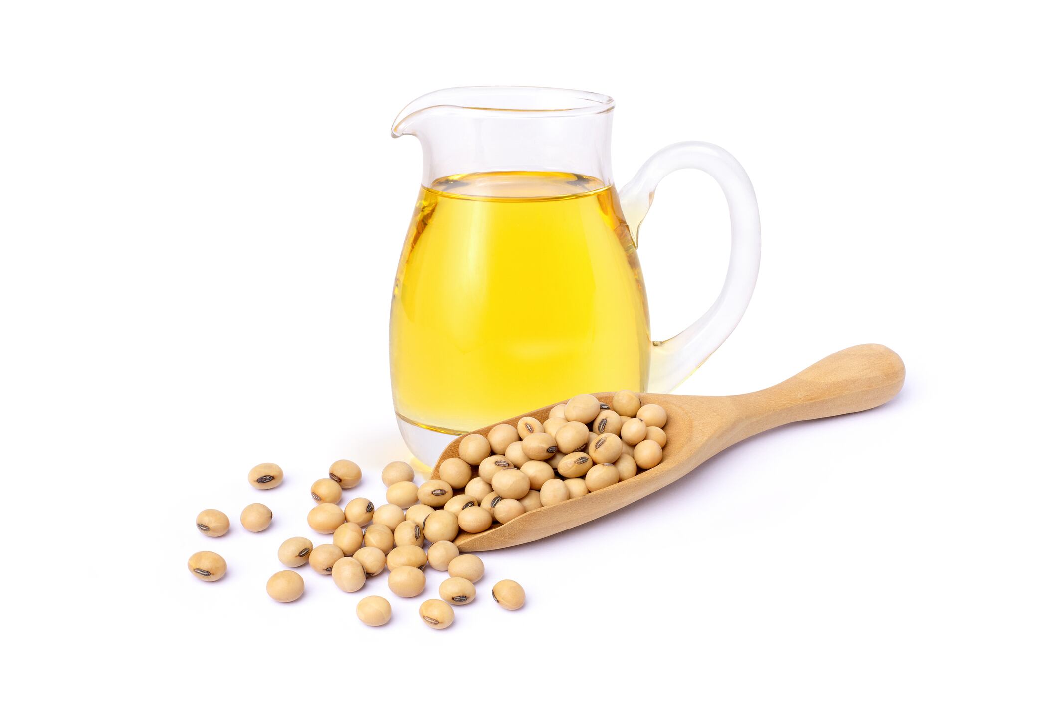 Soybean oil in glass bottle with soy beans in wooden scoop isolated on white background.