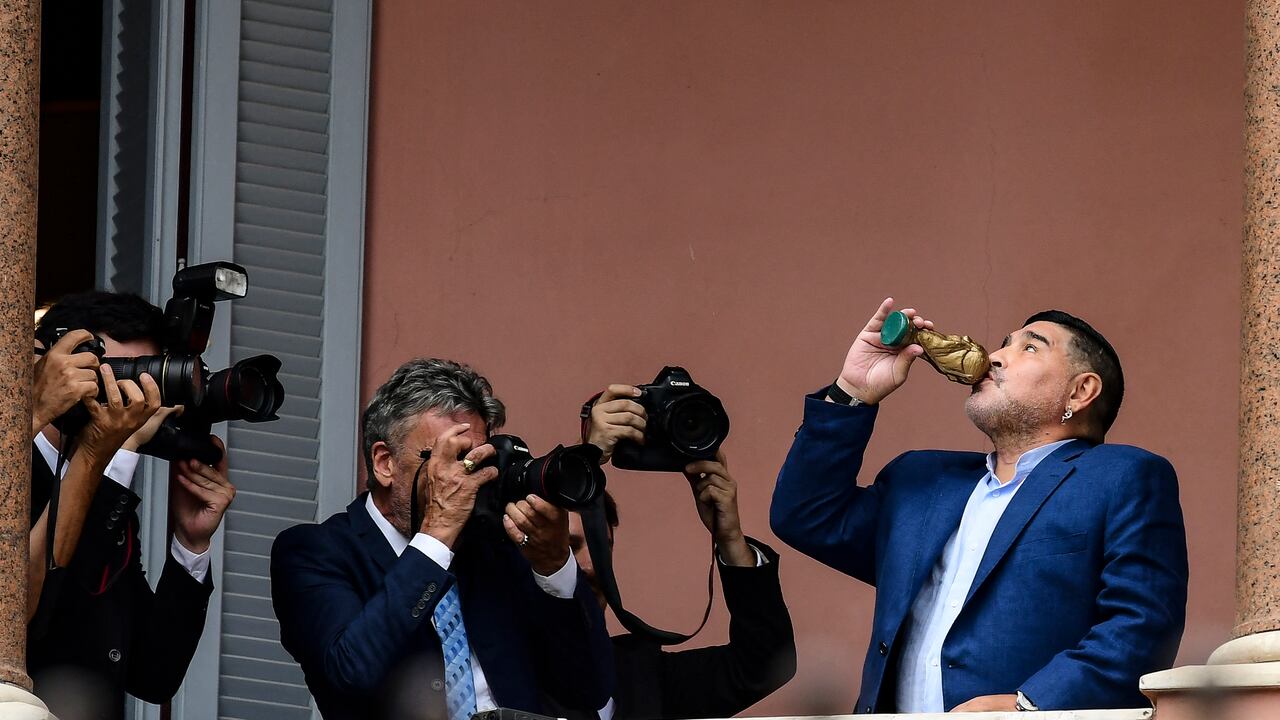 (FILES) In this file photo taken on December 26, 2019 Argentina's Gimnasia y Esgrima La Plata coach, former football star Diego Armando Maradona poses for a picture at the Casa Rosada presidential palace after a private meeting with Argentinian president Alberto Fernandez, in Buenos Aires. - Next November 25, 2021 marks the first anniversary of Diego Maradona's death. (Photo by RONALDO SCHEMIDT / AFP)