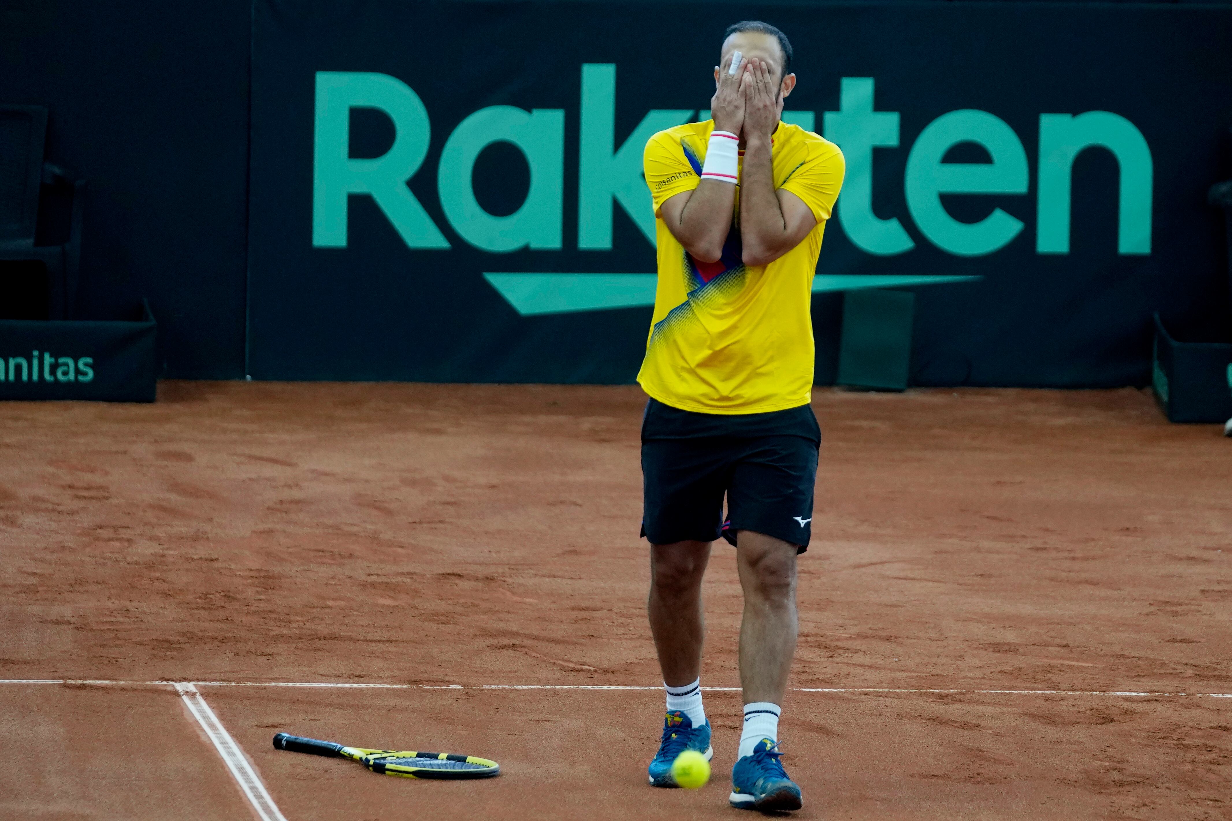 Colombia's Juan Cabal reacts after losing a point during a Davis Cup qualification doubles match against Neal Skupski and Dan Evans, of Britain, in Cota, Colombia, Saturday, Feb. 4, 2023. (AP Photo/Fernando Vergara)
