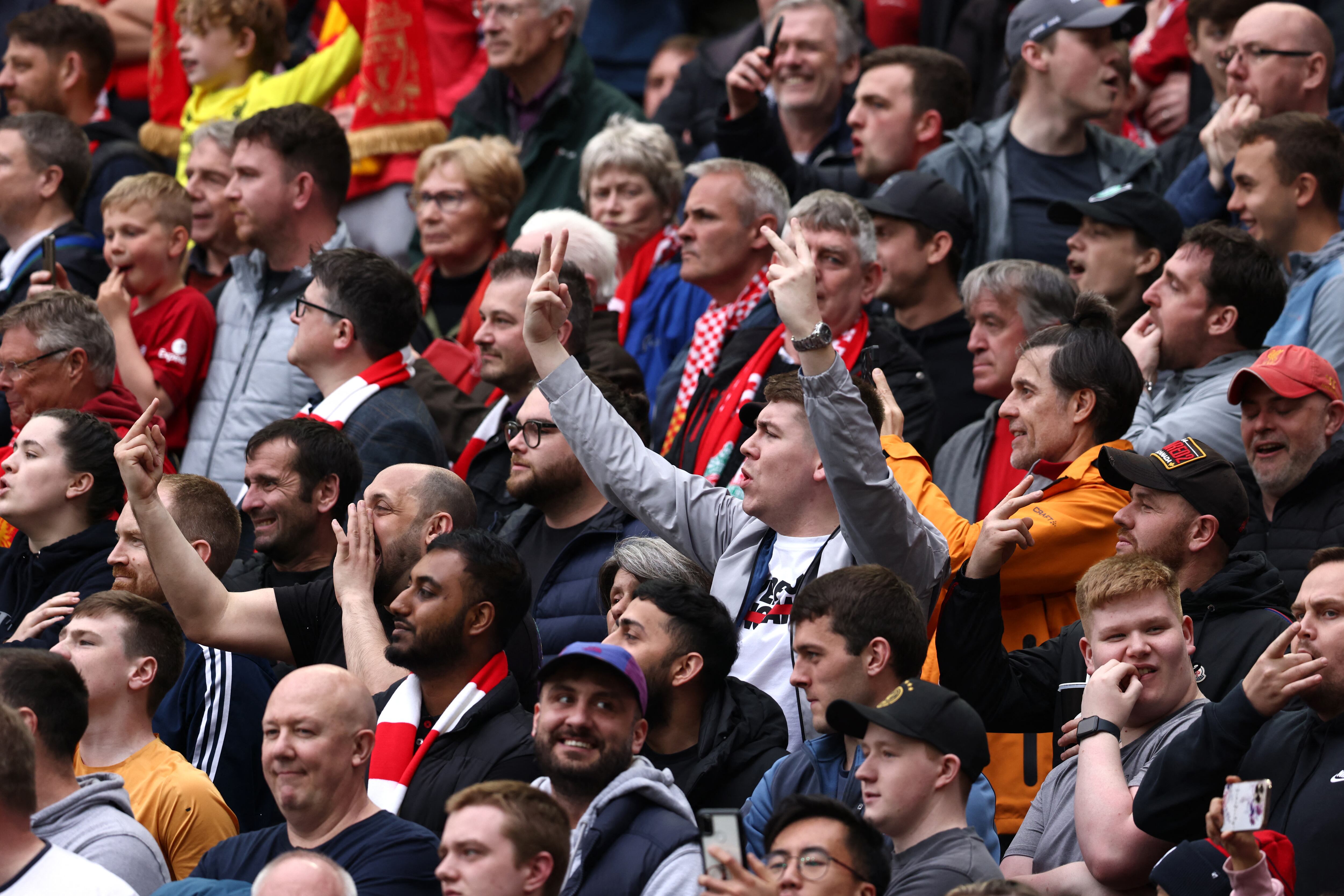 Liverpool's supporters gesture during the national anthem prior to the English Premier League football match between Liverpool and Brentford at Anfield in Liverpool, north west England on May 6, 2023. (Photo by DARREN STAPLES / AFP) / RESTRICTED TO EDITORIAL USE. No use with unauthorized audio, video, data, fixture lists, club/league logos or 'live' services. Online in-match use limited to 120 images. An additional 40 images may be used in extra time. No video emulation. Social media in-match use limited to 120 images. An additional 40 images may be used in extra time. No use in betting publications, games or single club/league/player publications. /