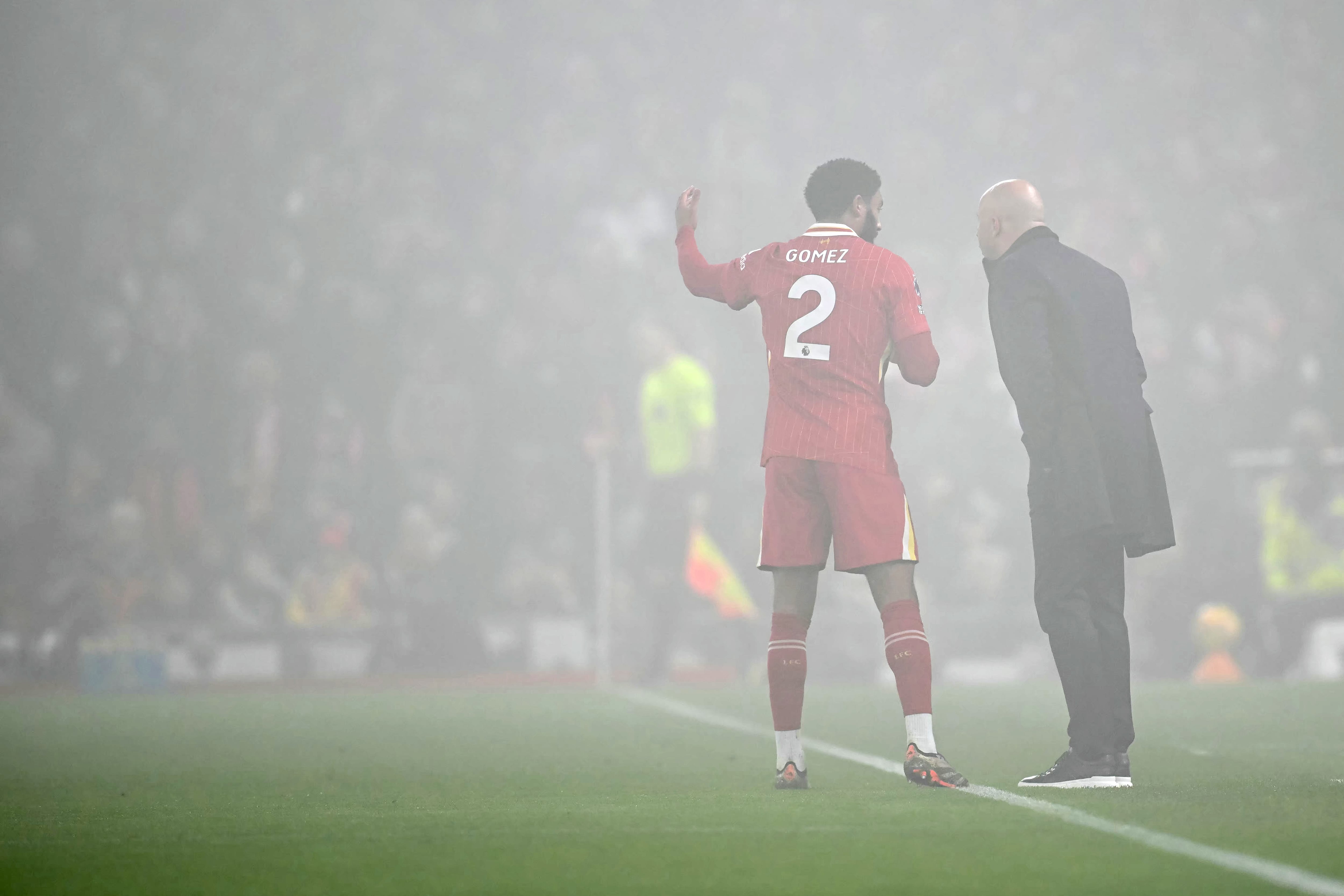 Liverpool's English defender #02 Joe Gomez talk to Liverpool's Dutch manager Arne Slot during the English Premier League football match between Liverpool and Leicester City at Anfield in Liverpool, north west England on December 26, 2024. (Photo by Paul ELLIS / AFP) / RESTRICTED TO EDITORIAL USE. No use with unauthorized audio, video, data, fixture lists, club/league logos or 'live' services. Online in-match use limited to 120 images. An additional 40 images may be used in extra time. No video emulation. Social media in-match use limited to 120 images. An additional 40 images may be used in extra time. No use in betting publications, games or single club/league/player publications. /