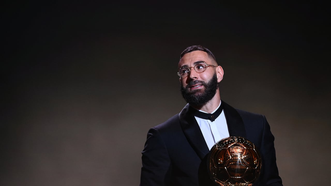 Real Madrid's French forward Karim Benzema receives the Ballon d'Or award during the 2022 Ballon d'Or France Football award ceremony at the Theatre du Chatelet in Paris on October 17, 2022. (Photo by FRANCK FIFE / AFP)
