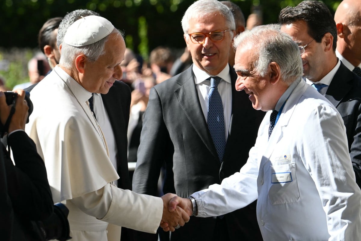 El Papa León XIV es recibido por el director sanitario Andrea Cambieri a su llegada al Hospital Universitario Gemelli para someterse a una operación destinada a extirpar un nódulo pulmonar, en Roma, el 13 de octubre de 2026.