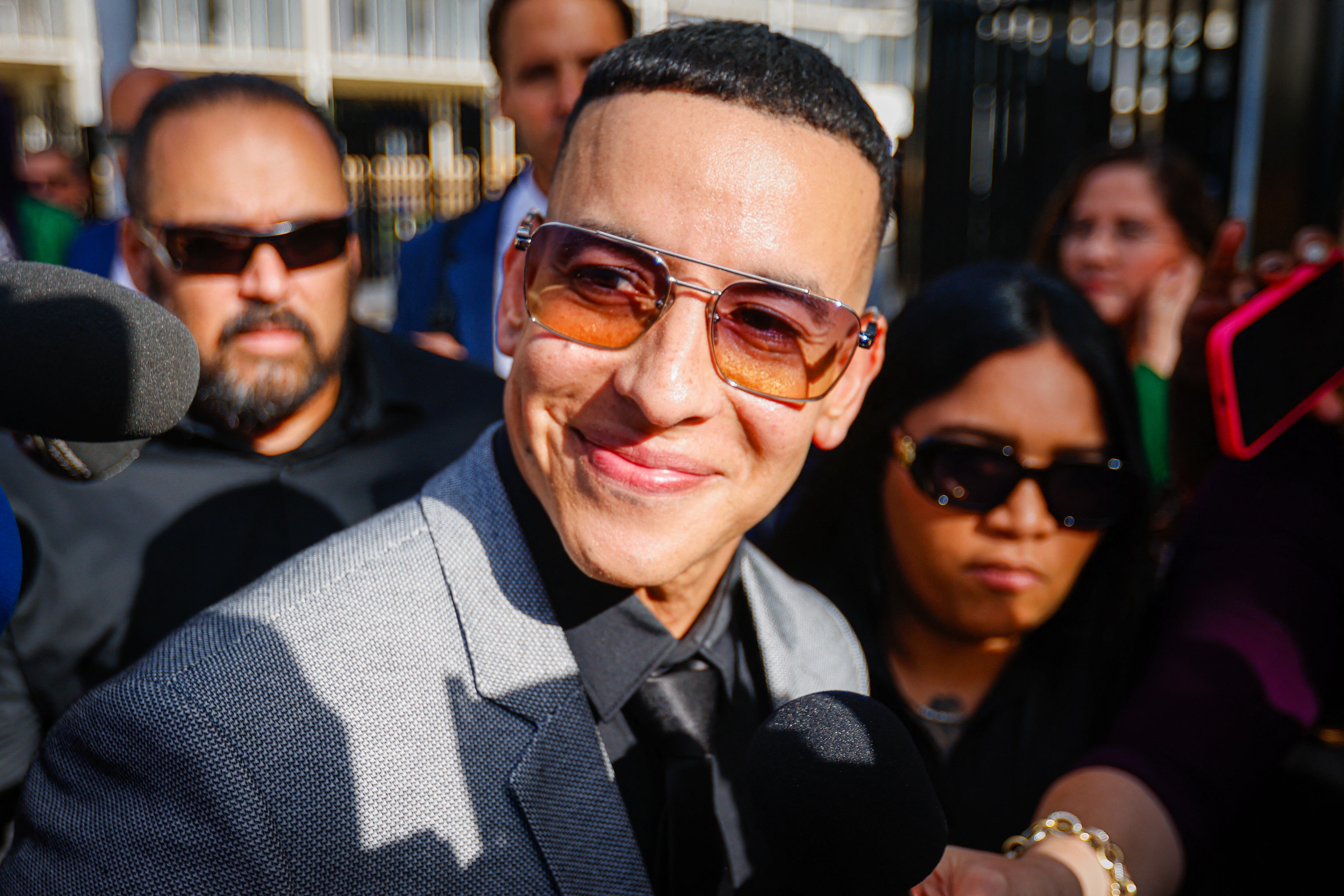 Daddy Yankee speaks to the media as he leaves the United States Federal Court for the District of Puerto Rico following a hearing in San Juan, Puerto Rico, on August 14, 2025. The rapper appears in court after filing a lawsuit against his ex-wife, Mireddys Gonzalez, and his former sister-in-law, Ayeicha Gonzalez, alleging they delete important information from the companies El Cartel Productions and Los Cangris Inc., seeking $12 million in damages. (Photo by Edgardo Medina/NurPhoto) (Photo by Edgardo Medina / NurPhoto via AFP)