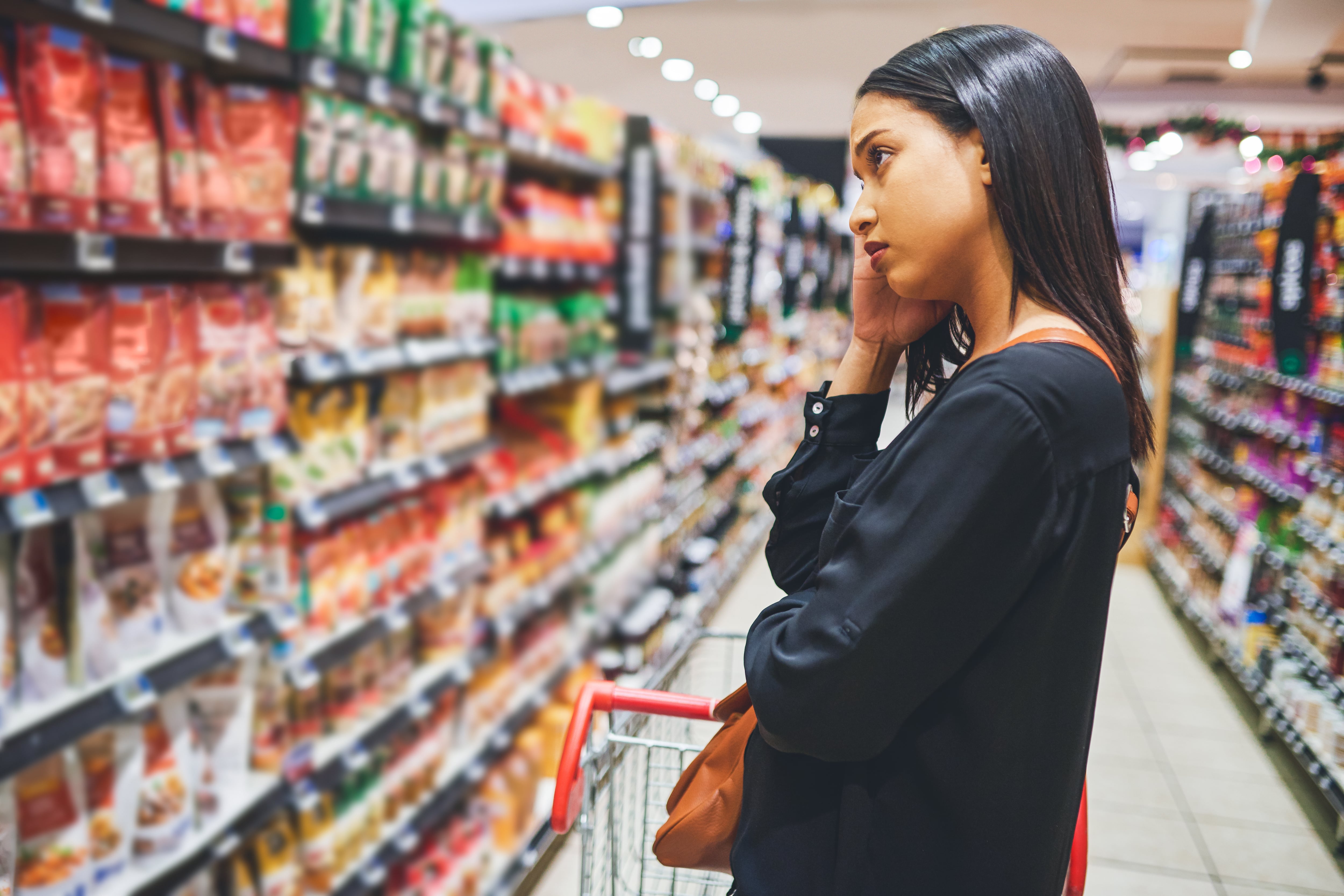 Shot of a young woman shopping in a grocery store