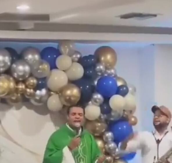 El sacerdote era acompañado por un hombre con un instrumento mientras cantaba el vallenato
