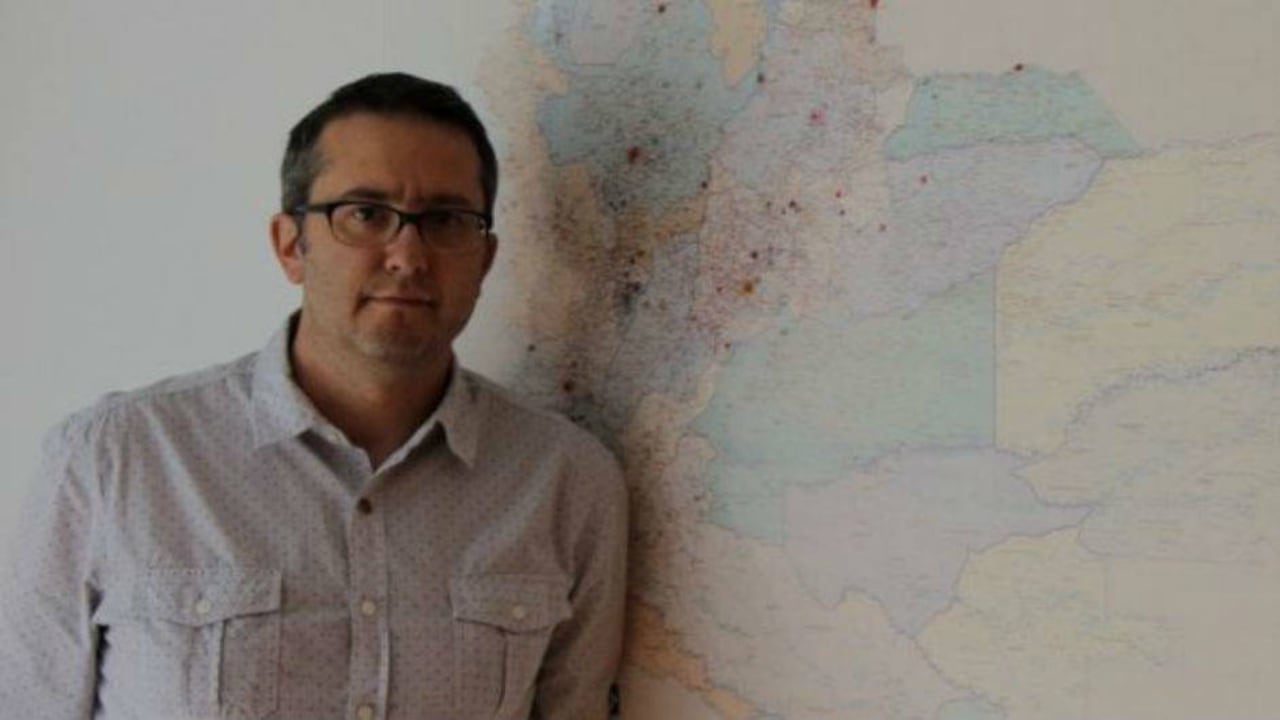 Natalio Cosoy junto al mapa que hay en la oficina de la corresponsalía de BBC Mundo en Colombia.