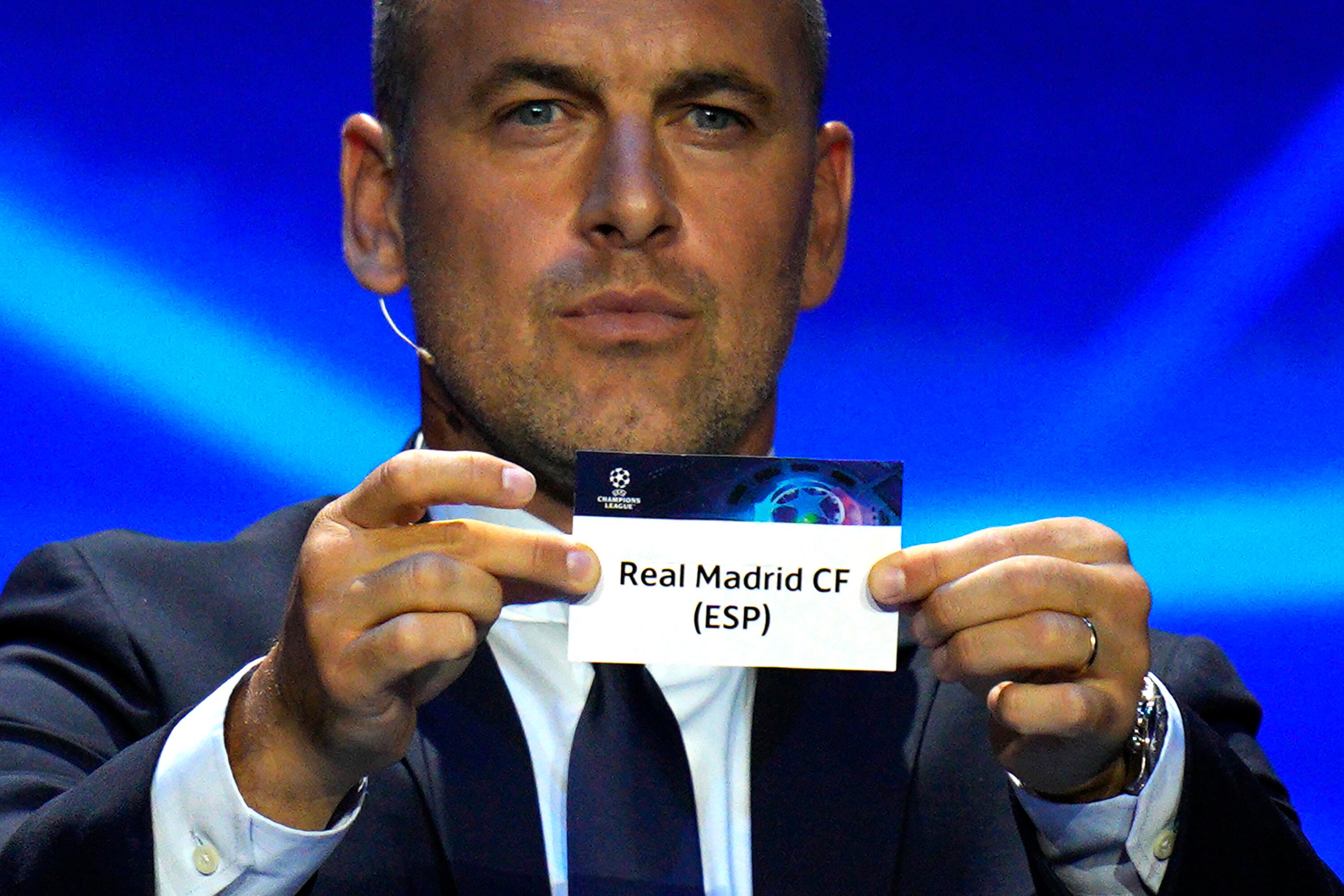 Former soccer star Joe Cole shows a ticket of soccer club Real Madrid during the 2023/24 UEFA Champions League group stage draw at the Grimaldi Forum in Monaco, Thursday, Aug. 31, 2013. (AP Photo/Daniel Cole)