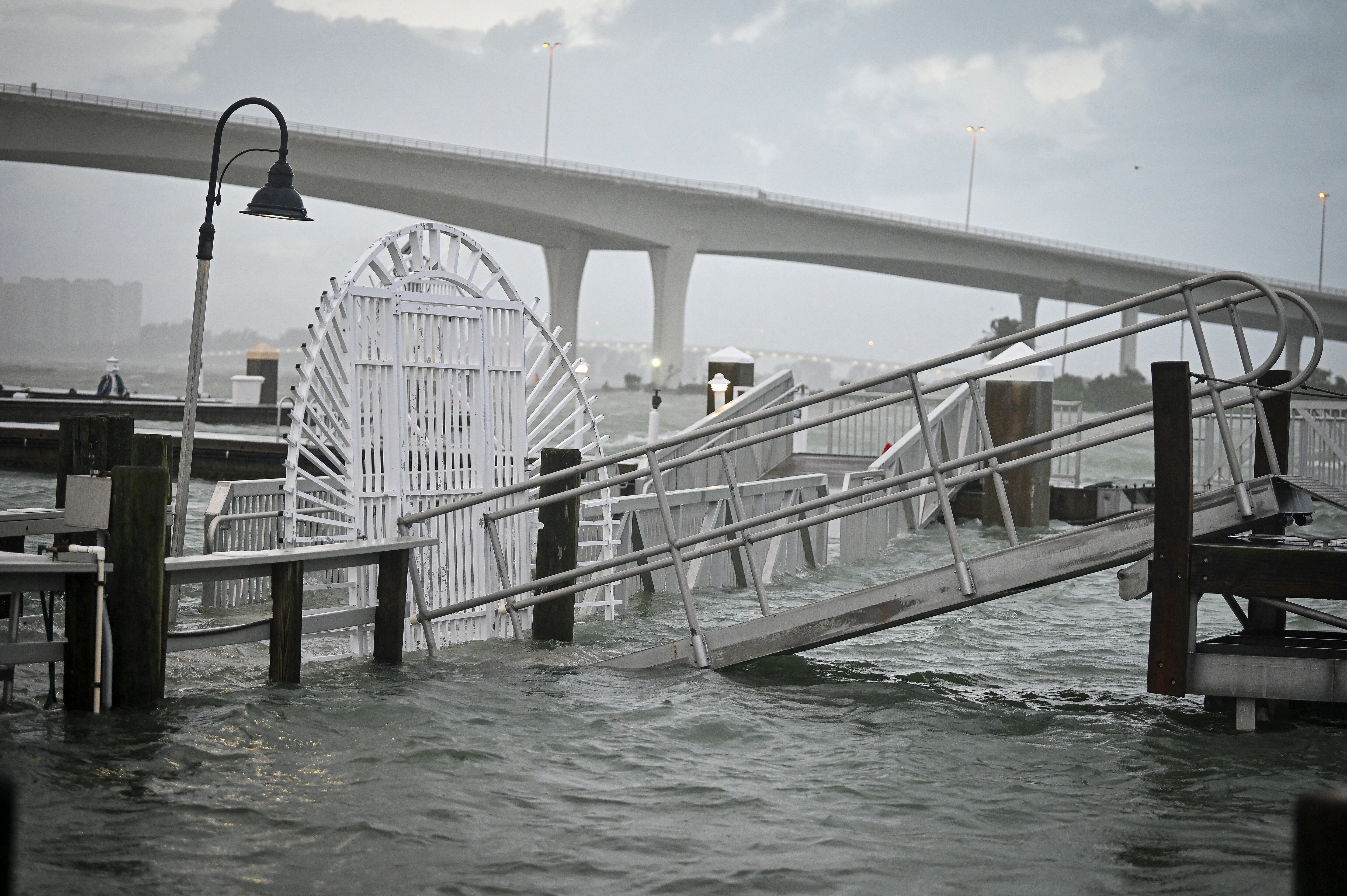 A boardwalk at the Clearwater Harbor Marina in Clearwater, Florida, is flooded by the rising tide on August 30, 2023, after Hurricane Idalia made landfall. Idalia barreled into the northwest Florida coast as a powerful Category 3 hurricane on Wednesday morning, the US National Hurricane Center said. "Extremely dangerous Category 3 Hurricane #Idalia makes landfall in the Florida Big Bend," it posted on X, formerly known as Twitter, adding that Idalia was causing "catastrophic storm surge and damaging winds." (Photo by Miguel J. Rodriguez Carrillo / AFP)