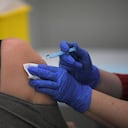 A woman receives a dose of the AstraZeneca's Covid-19 vaccine at a vaccination center on April 26, 2021 in Barcelona amid a campaign of vaccination to fight the spread of coronavirus. (Photo by LLUIS GENE / AFP)